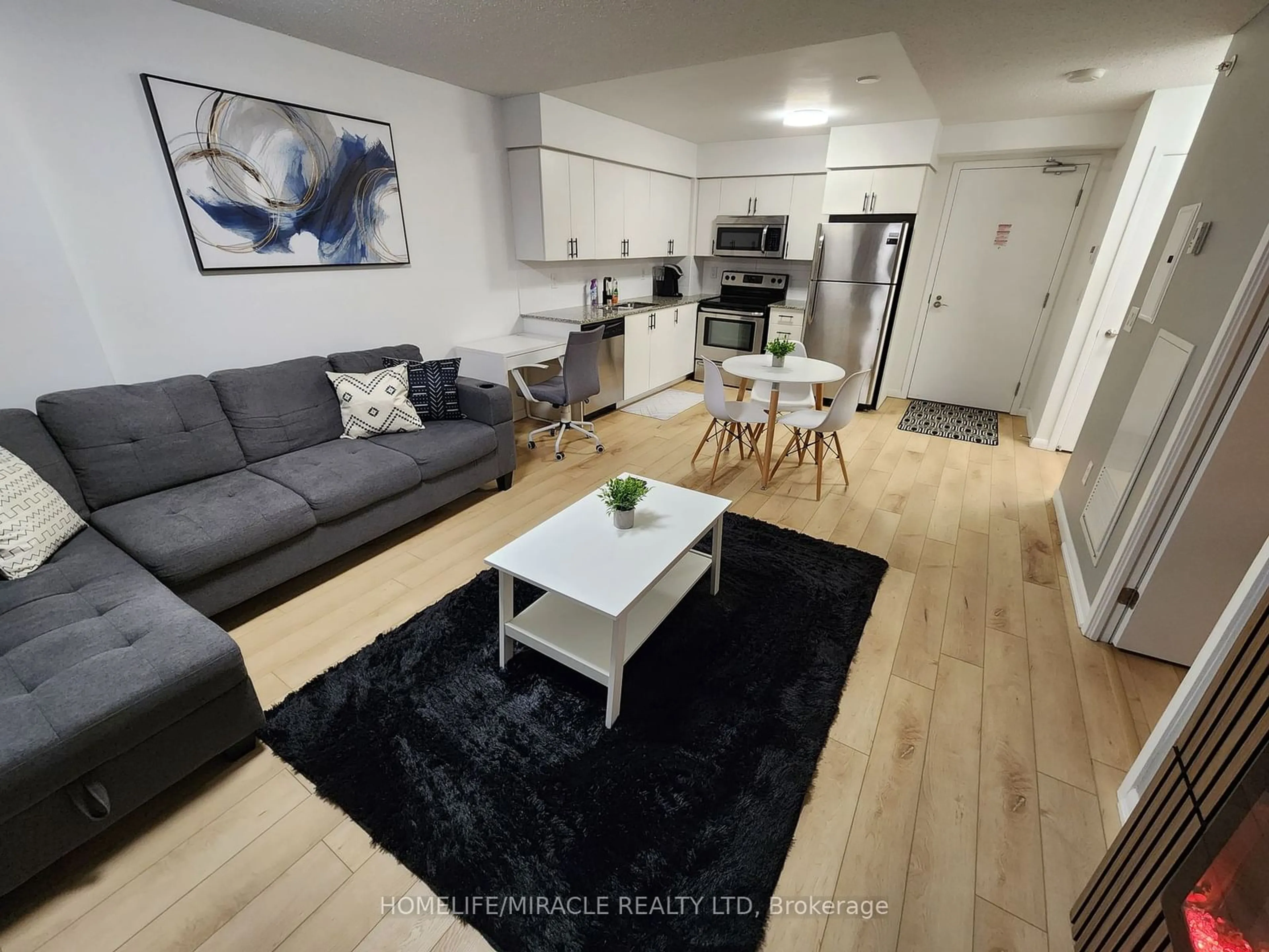 Living room with furniture, wood/laminate floor for 800 Lawrence Ave #407, Toronto Ontario M6A 0B7