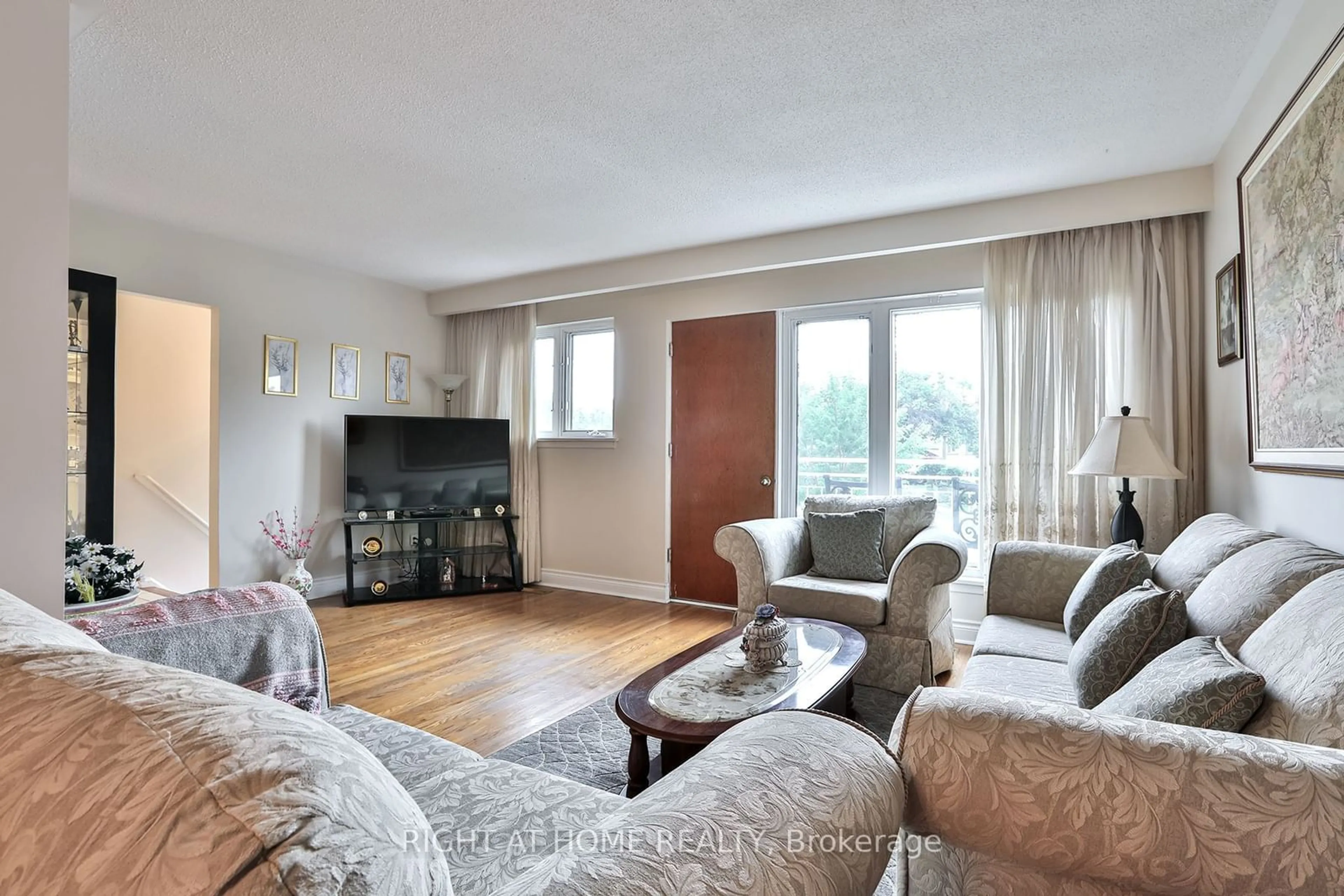 Living room with furniture, wood/laminate floor for 15 Tinton Cres, Toronto Ontario M9V 2H9