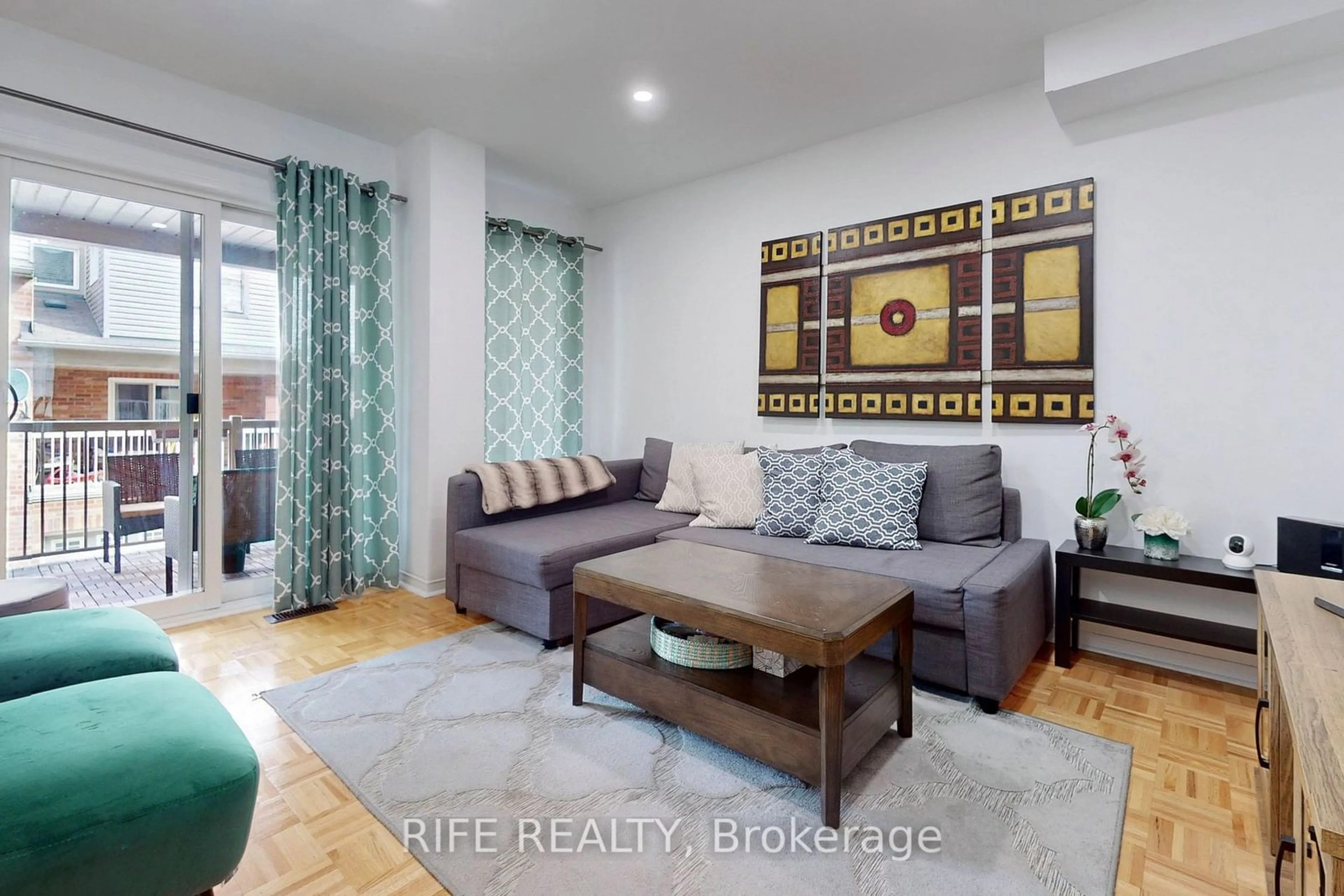 Living room with furniture, wood/laminate floor for 76 Joseph Griffith Lane, Toronto Ontario M3L 0C7