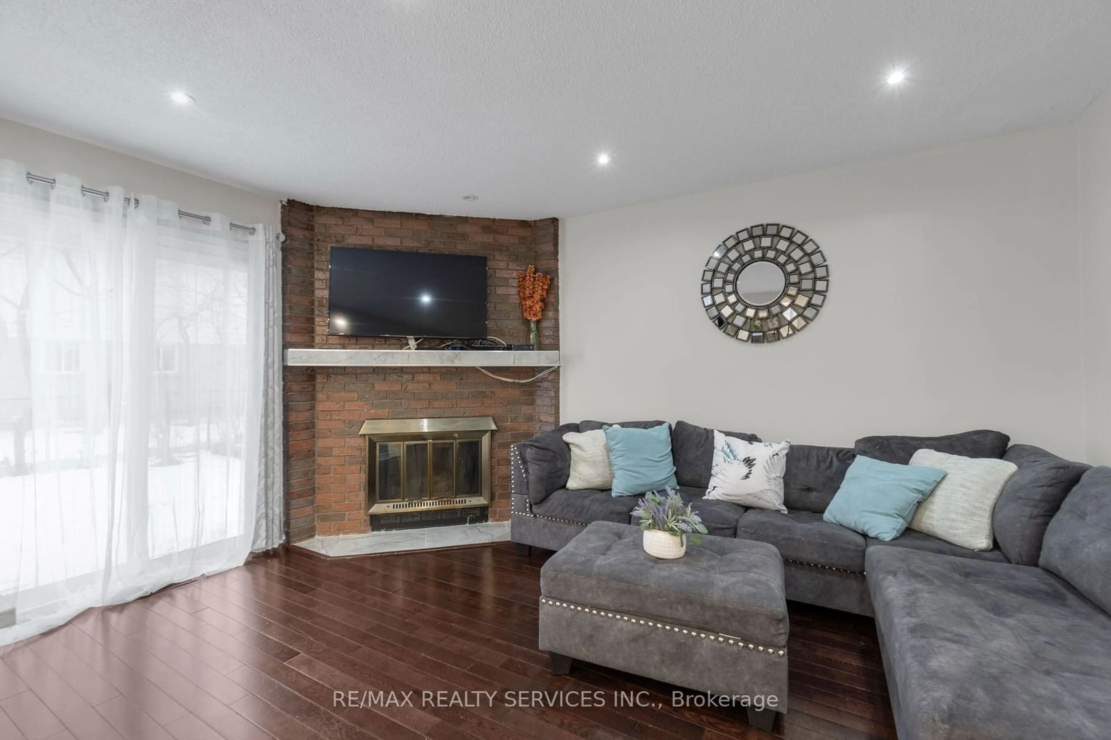 Living room with furniture, wood/laminate floor for 95 Martindale Cres, Brampton Ontario L6X 2T8