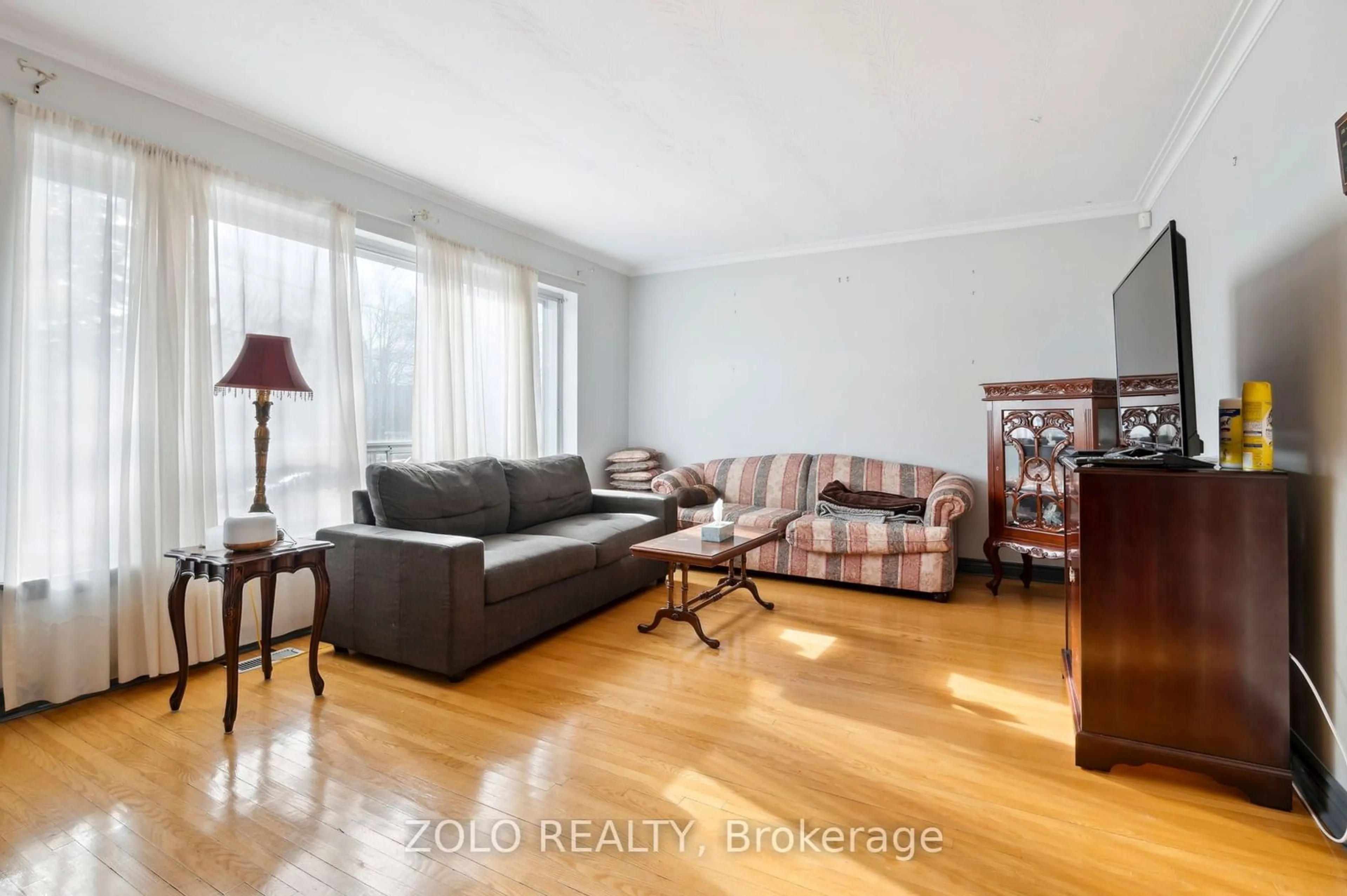 Living room with furniture, wood/laminate floor for 65 Ridge Point Cres, Toronto Ontario M6M 2Z8