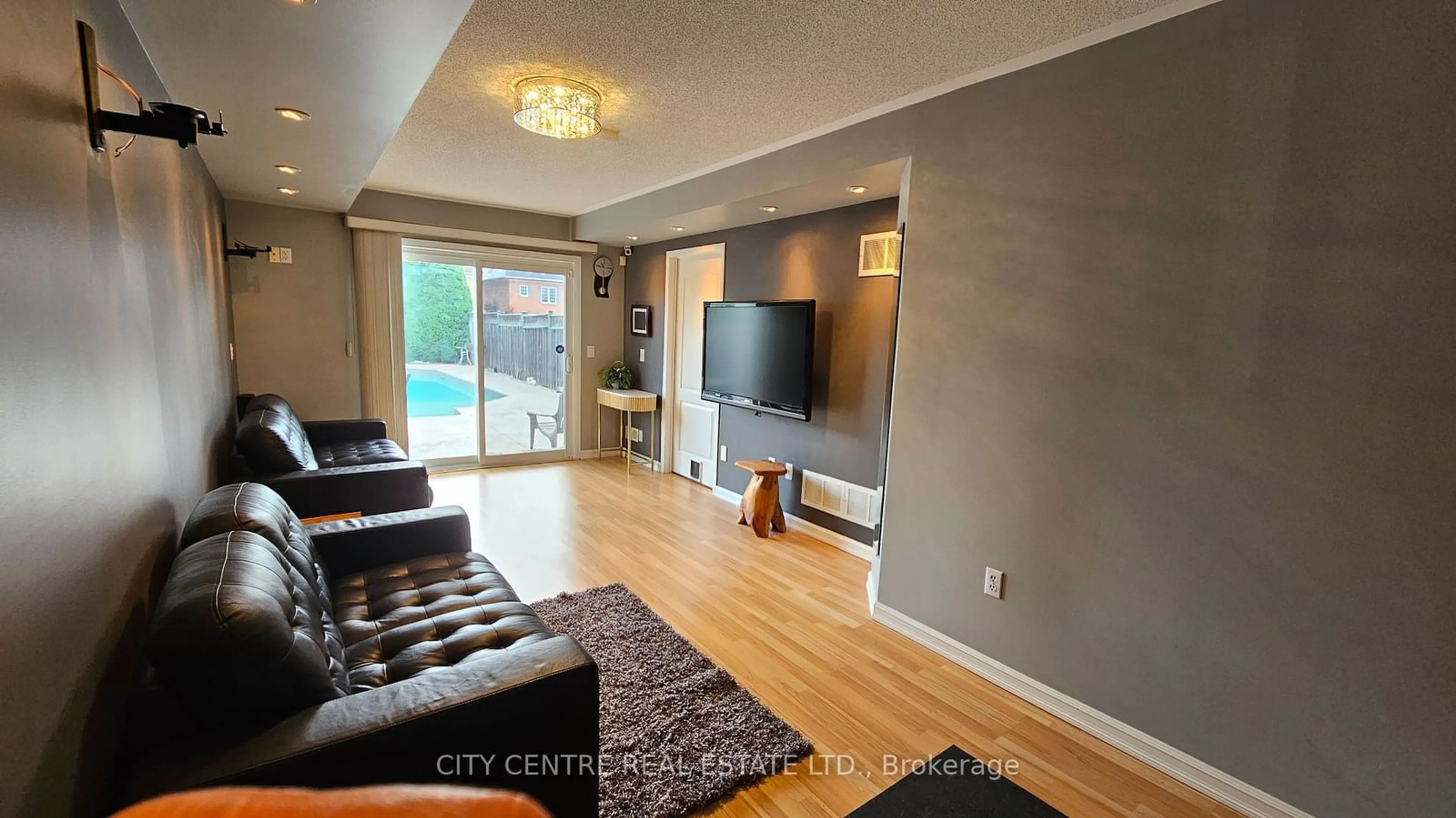 Living room with furniture, wood/laminate floor for 4972 Southampton Dr, Mississauga Ontario L5M 7P9