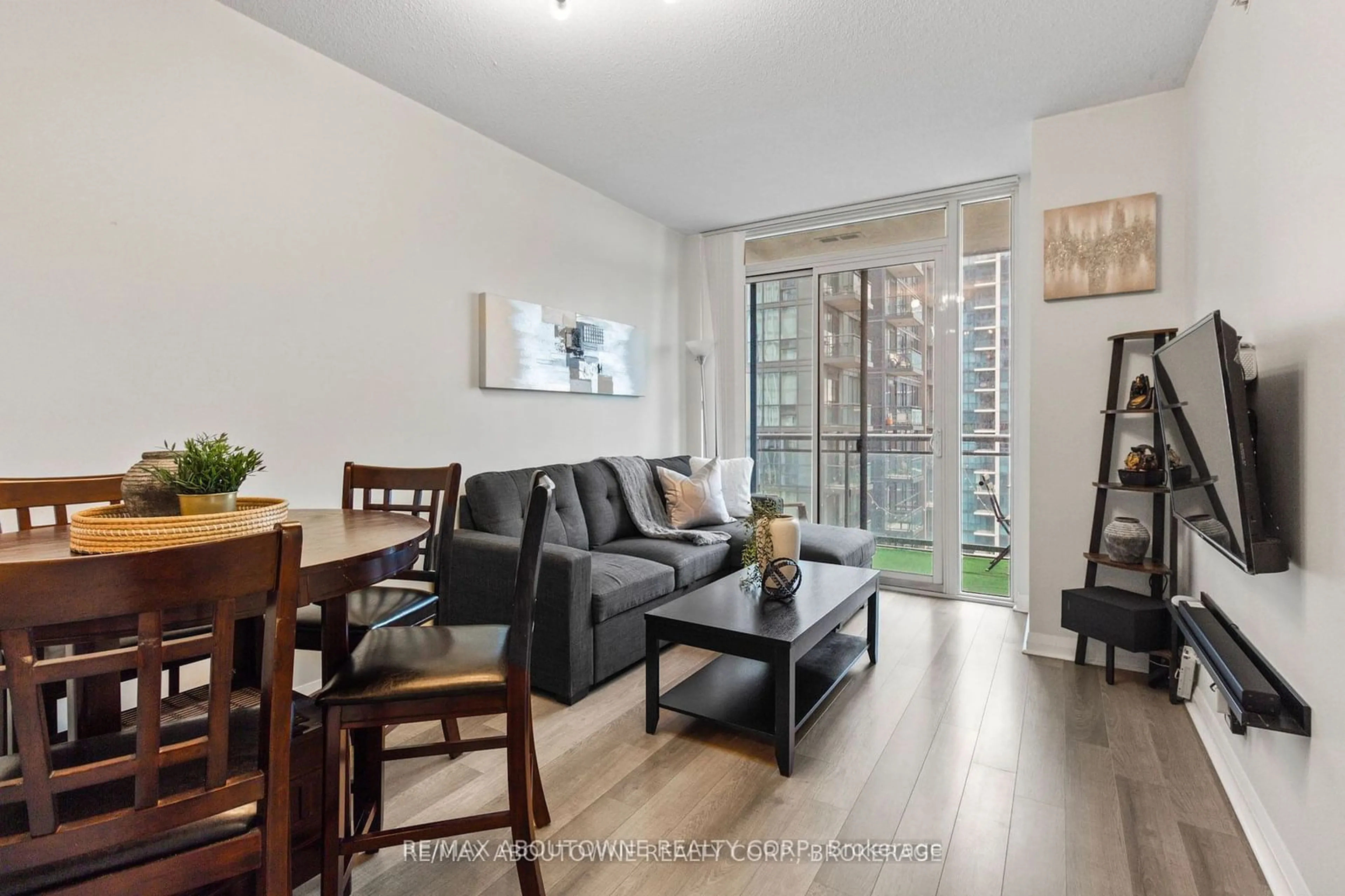 Living room with furniture, wood/laminate floor for 5033 Four Springs Ave #1811, Mississauga Ontario L5R 0G6