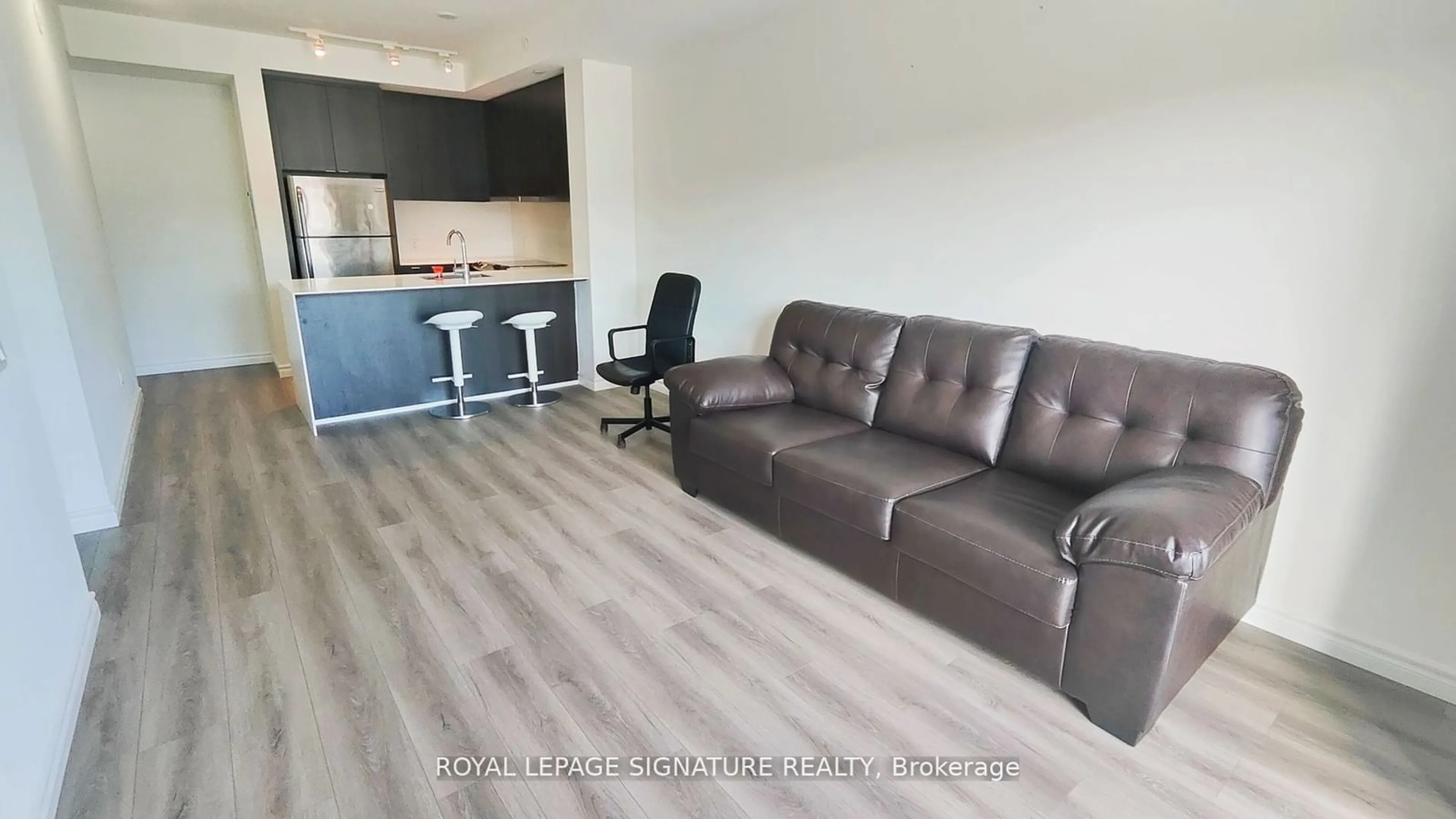 Living room with furniture, wood/laminate floor for 5005 Harvard Rd #306, Mississauga Ontario L5M 0W5