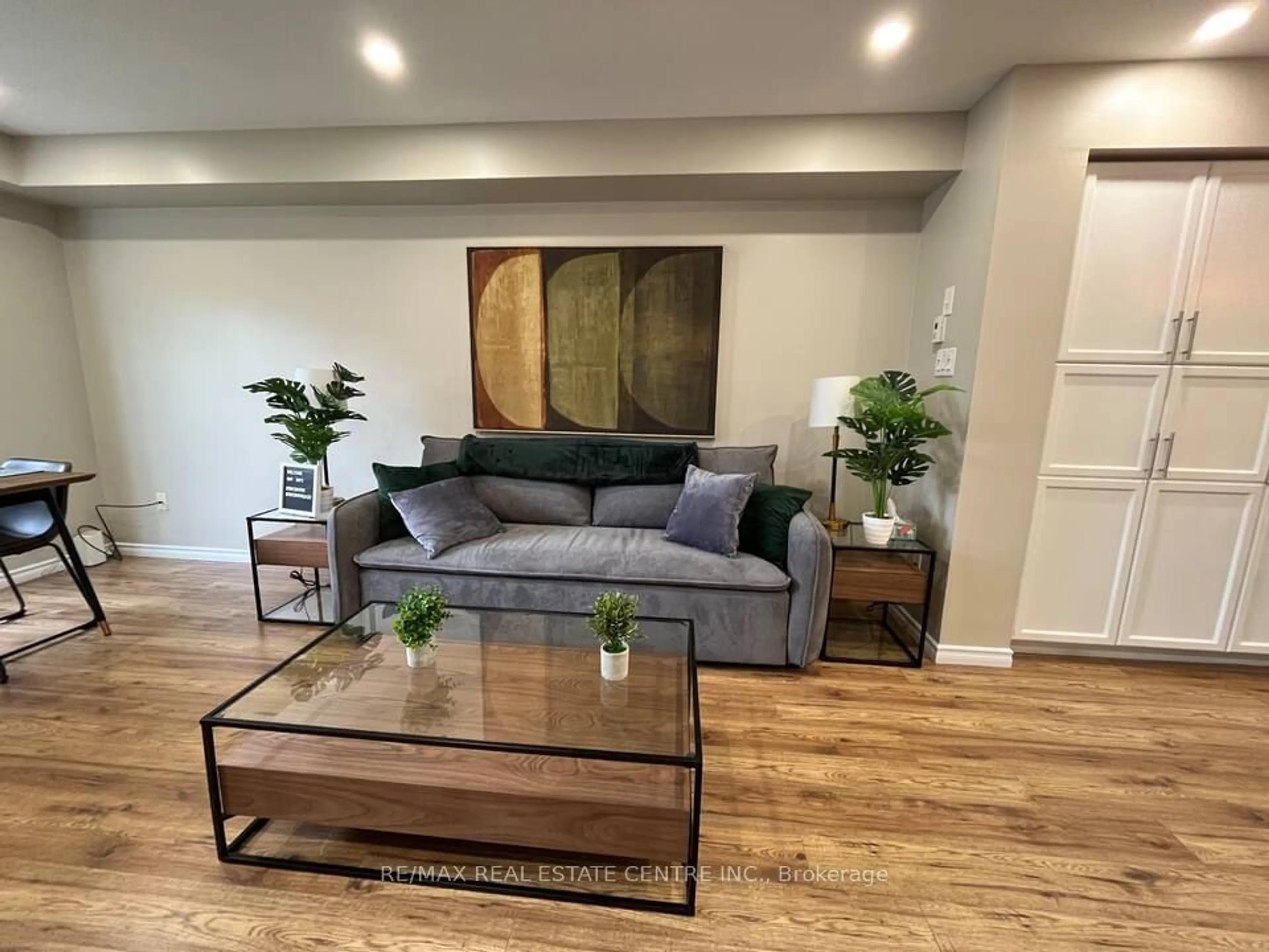 Living room with furniture, wood/laminate floor for 3050 Erin Centre Blvd #122, Mississauga Ontario L5M 0P5