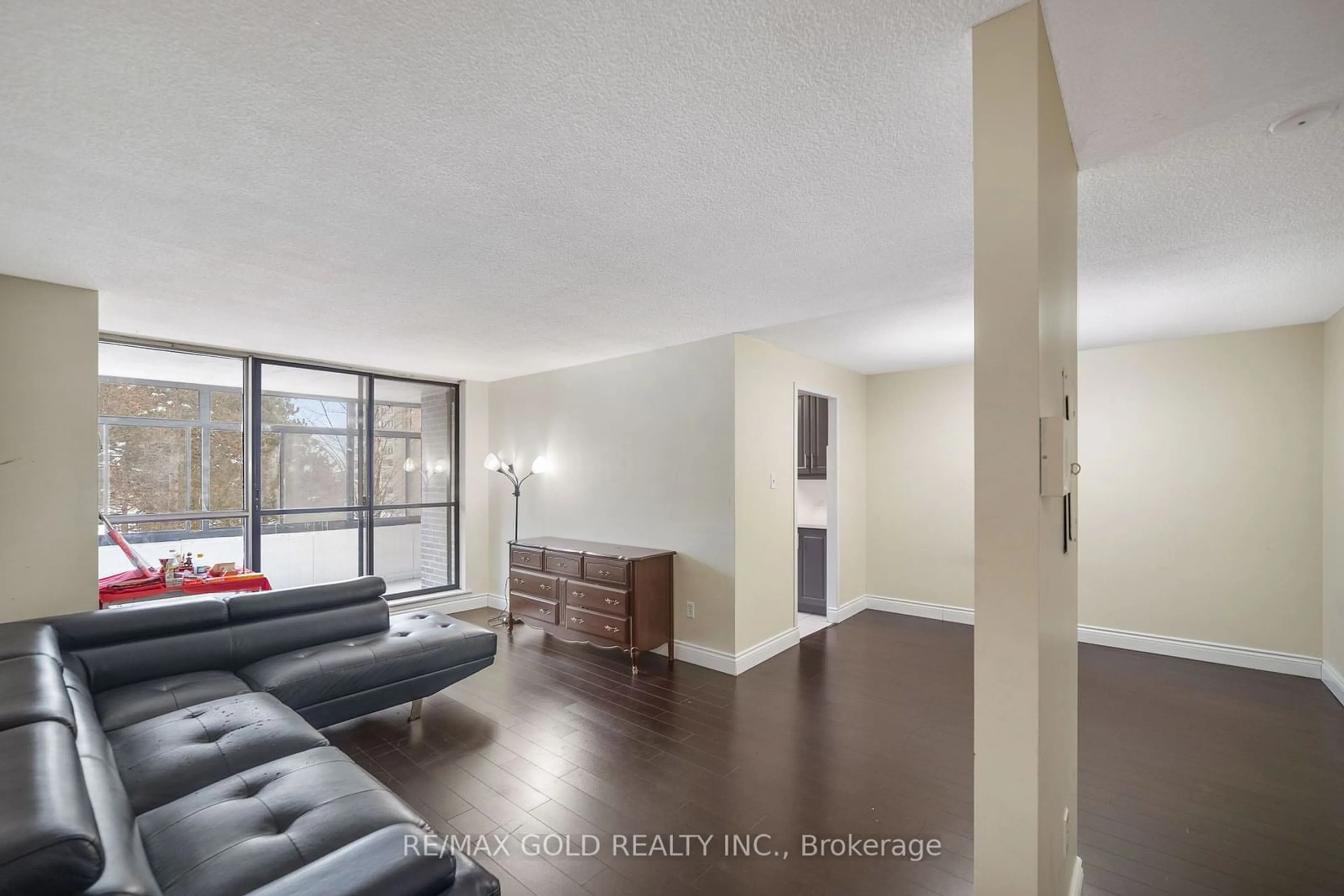 Living room with furniture, wood/laminate floor for 15 Kensington Rd #307, Brampton Ontario L6T 3W8