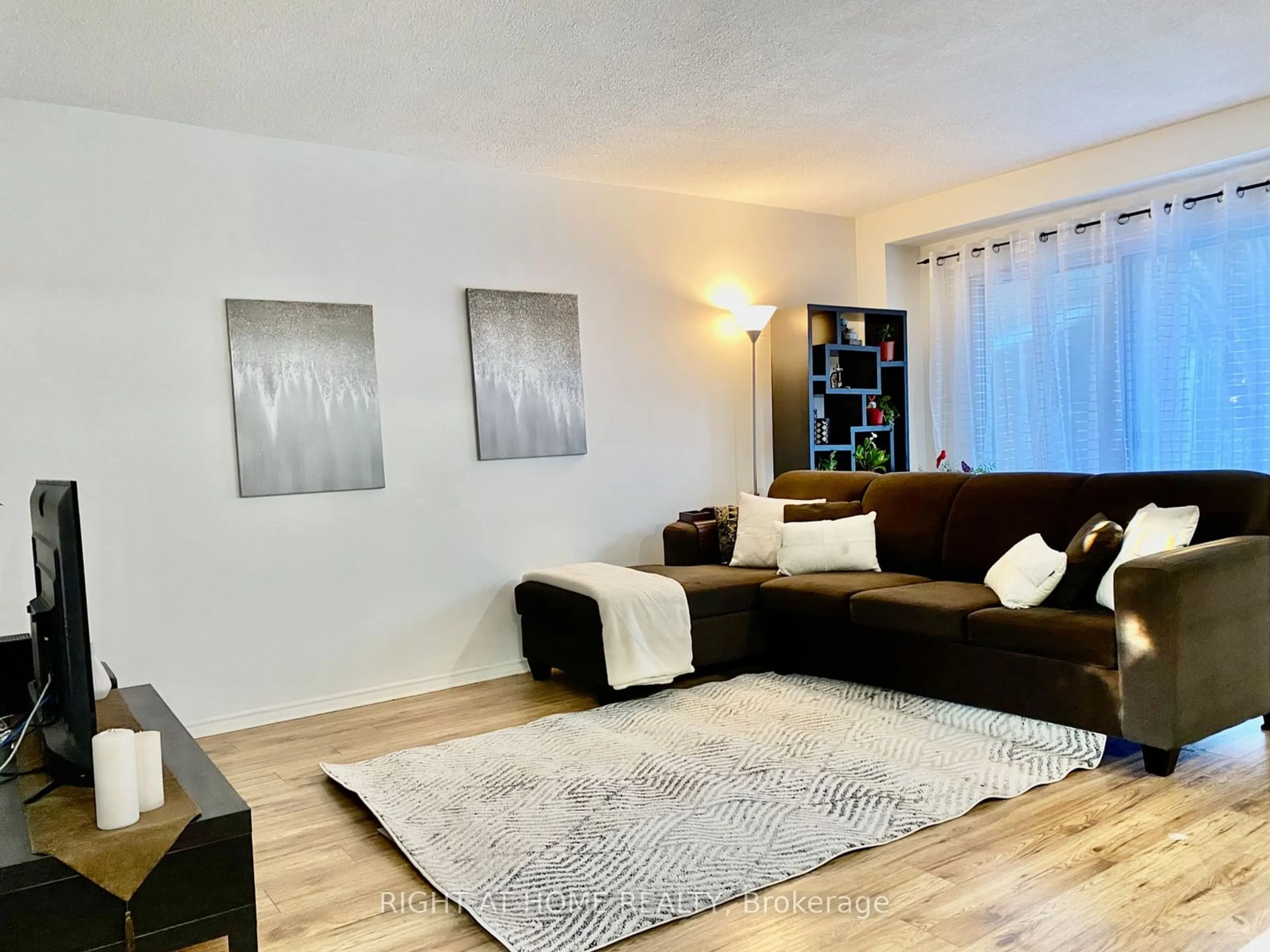 Living room with furniture, wood/laminate floor for 453 Woodview Rd #7, Burlington Ontario L7N 2Z9