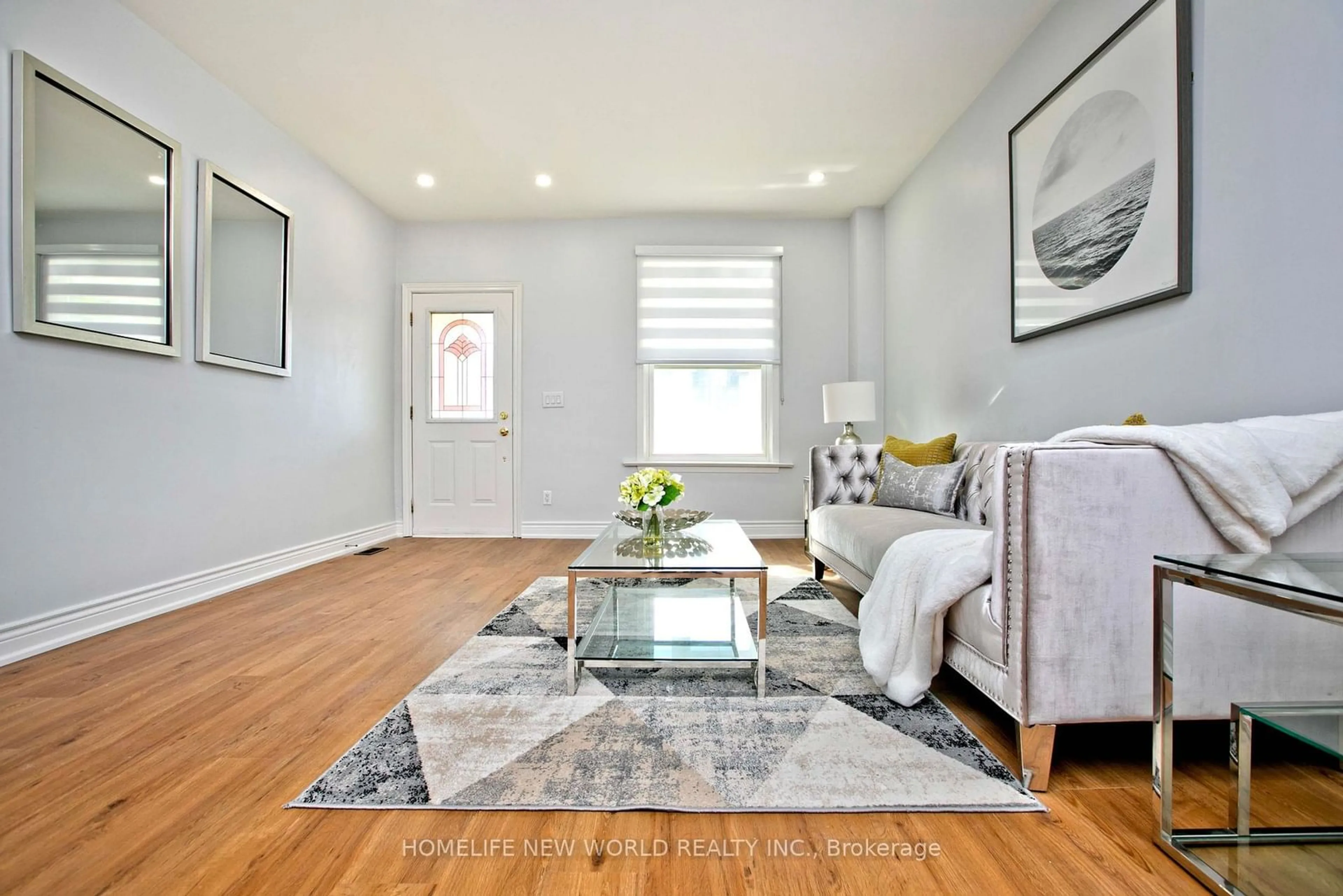 Living room with furniture, wood/laminate floor for 19 Britannia Ave, Toronto Ontario M6N 3T6