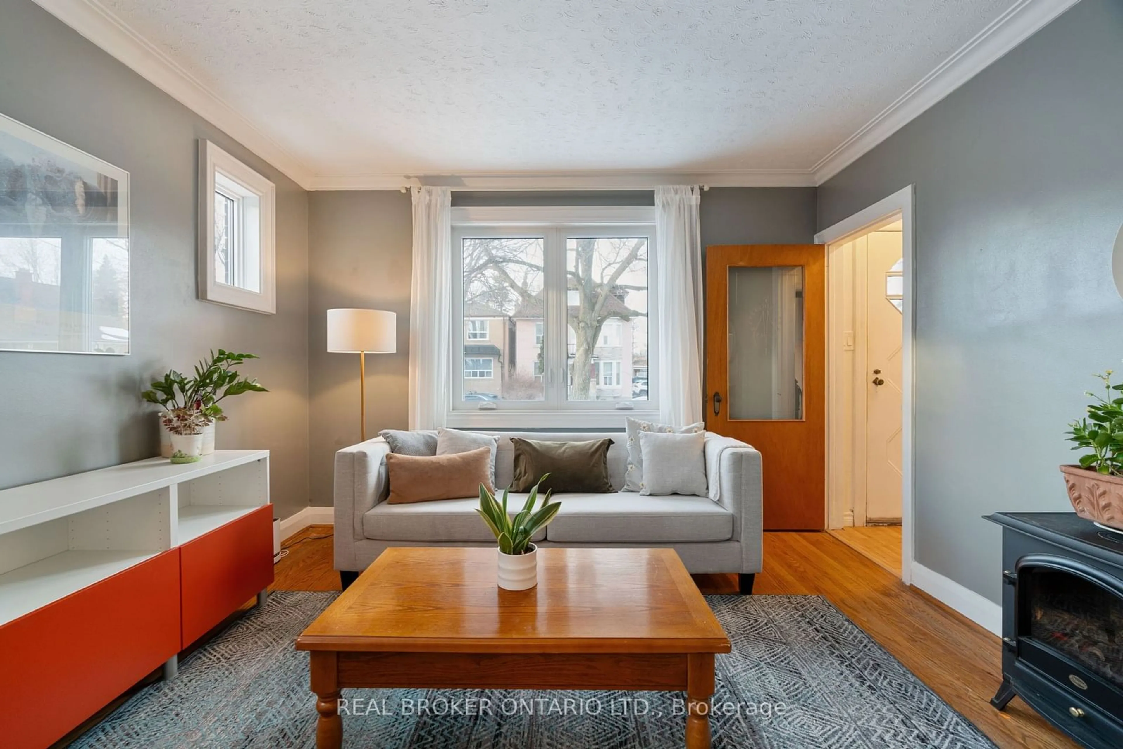 Living room with furniture, wood/laminate floor for 21 Edmund Ave, Toronto Ontario M9N 1A2