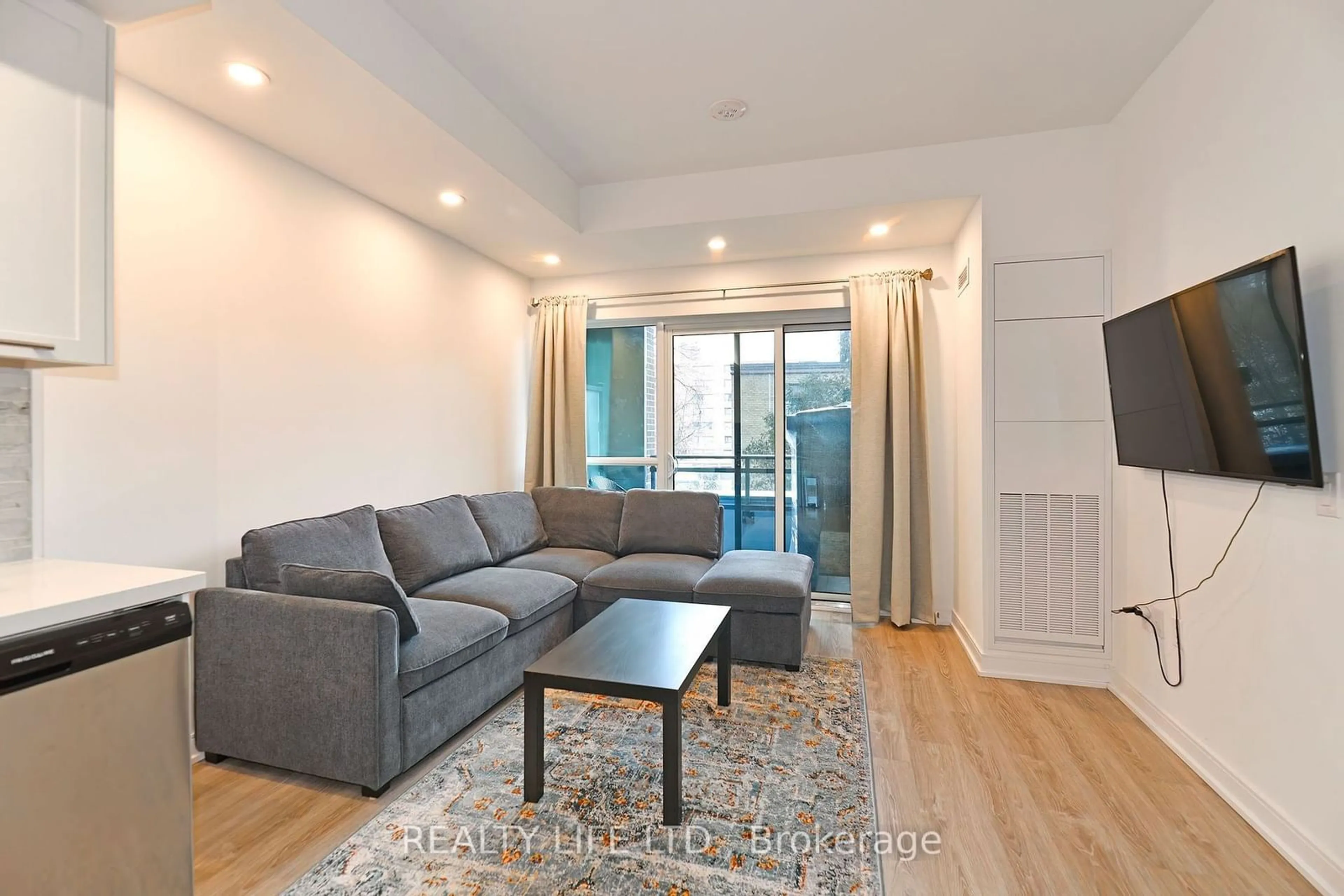 Living room with furniture, wood/laminate floor for 25 Neighbourhood Lane #310, Toronto Ontario M8Y 0C4