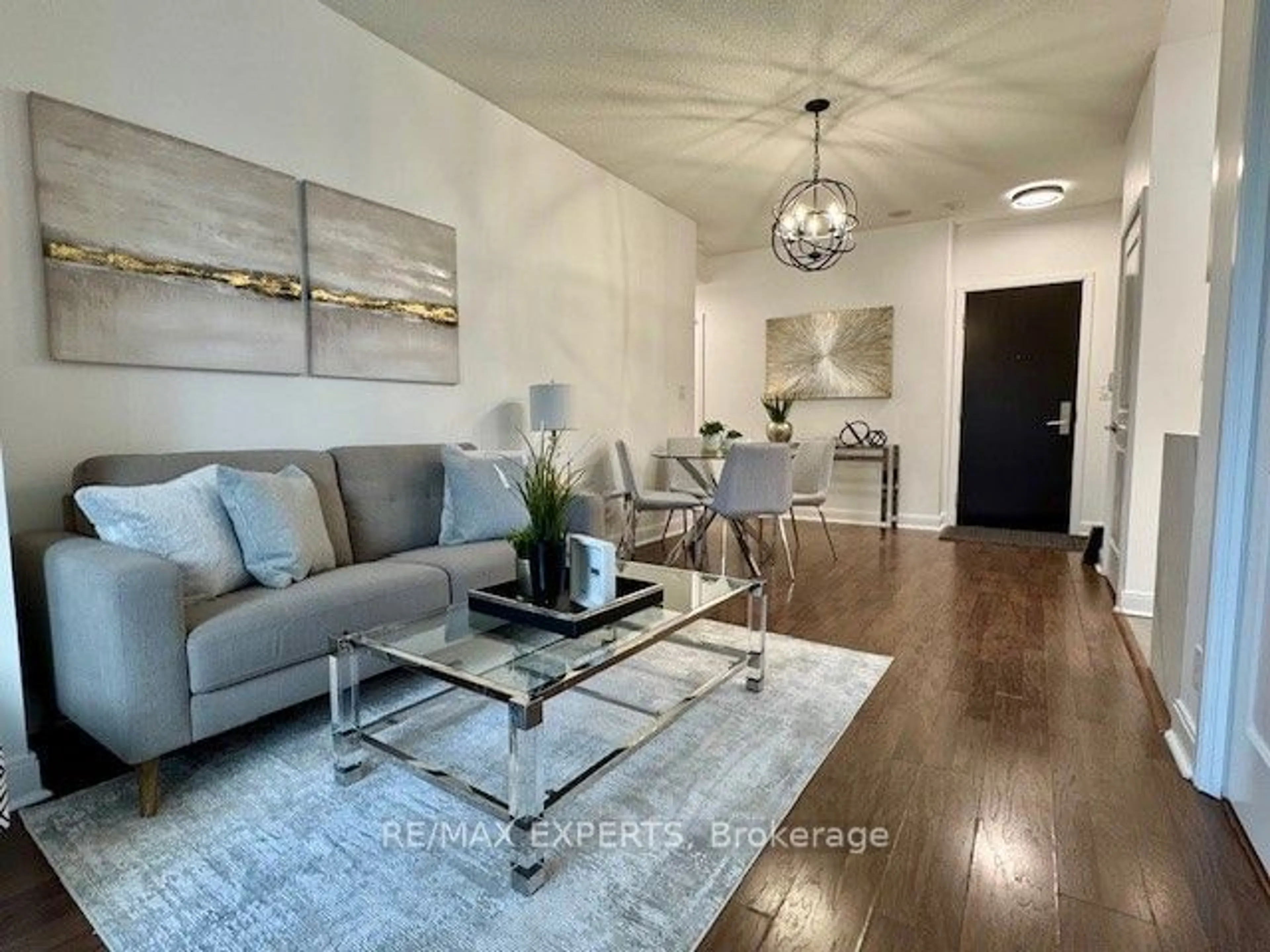 Living room with furniture, wood/laminate floor for 60 Absolute Ave #305, Mississauga Ontario L4Z 0A9