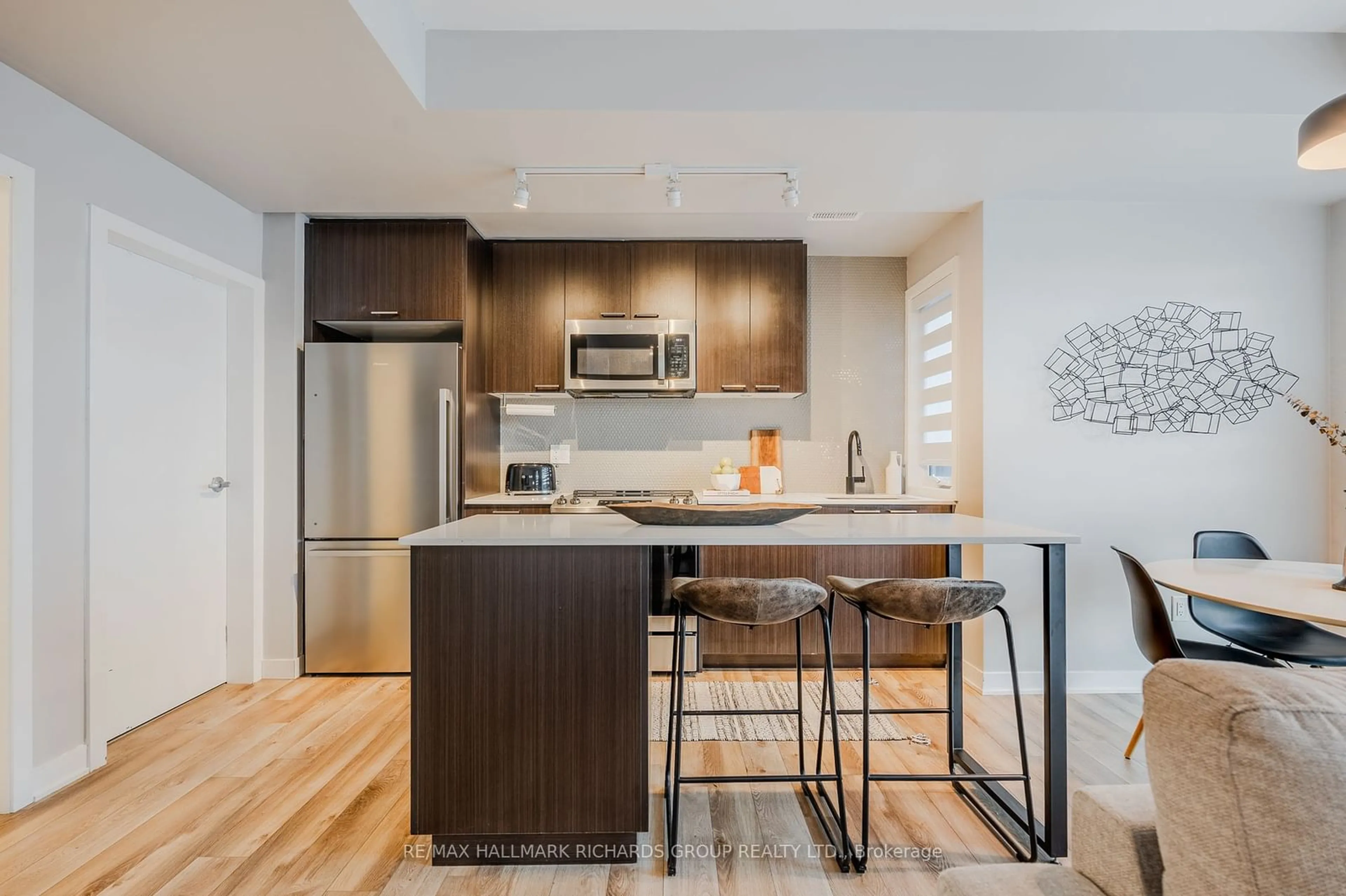 Open concept kitchen, wood/laminate floor for 20 Ed Clark Gardens Blvd #TH6, Toronto Ontario M6N 0B5