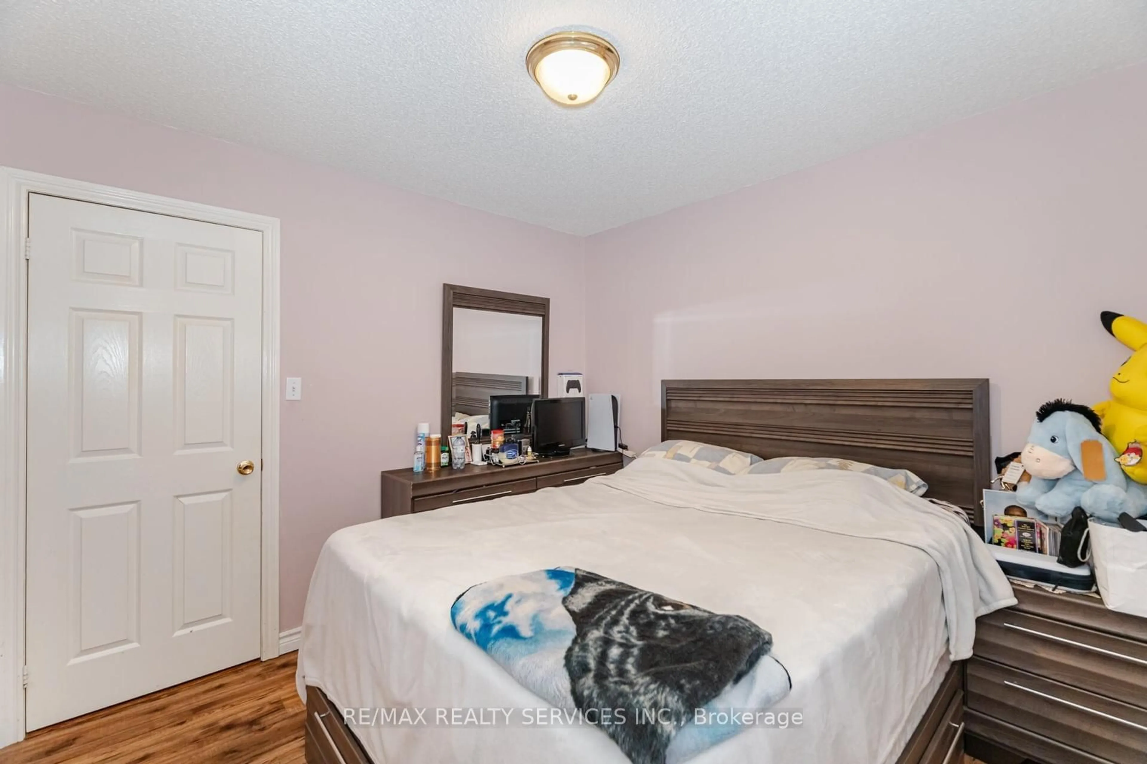 Bedroom with bed, wood/laminate floor for 11 Todmorden Dr, Brampton Ontario L7A 1M5