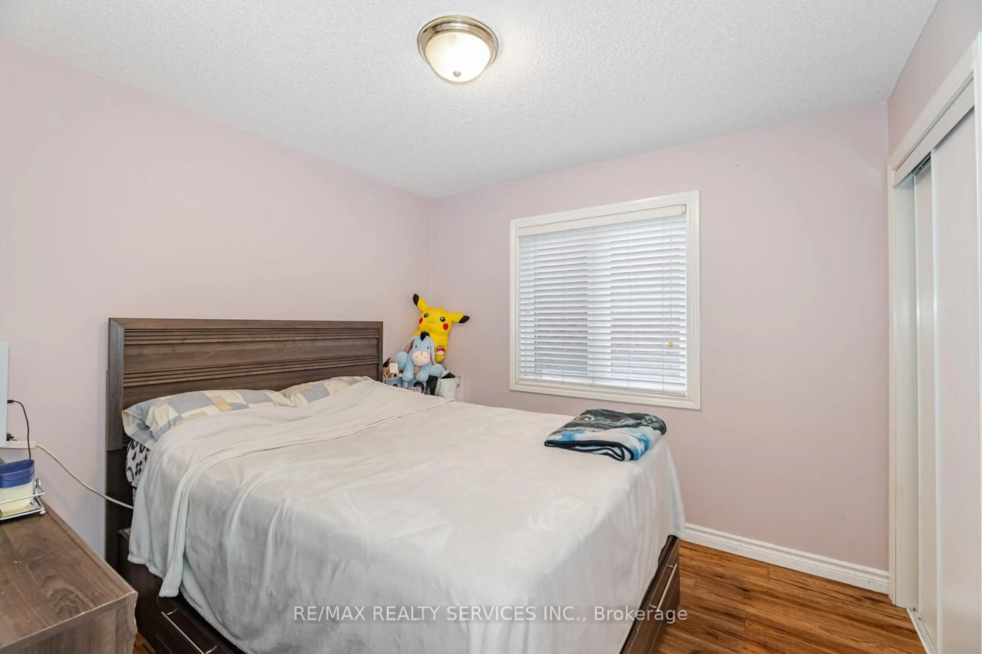 Bedroom with bed, wood/laminate floor for 11 Todmorden Dr, Brampton Ontario L7A 1M5