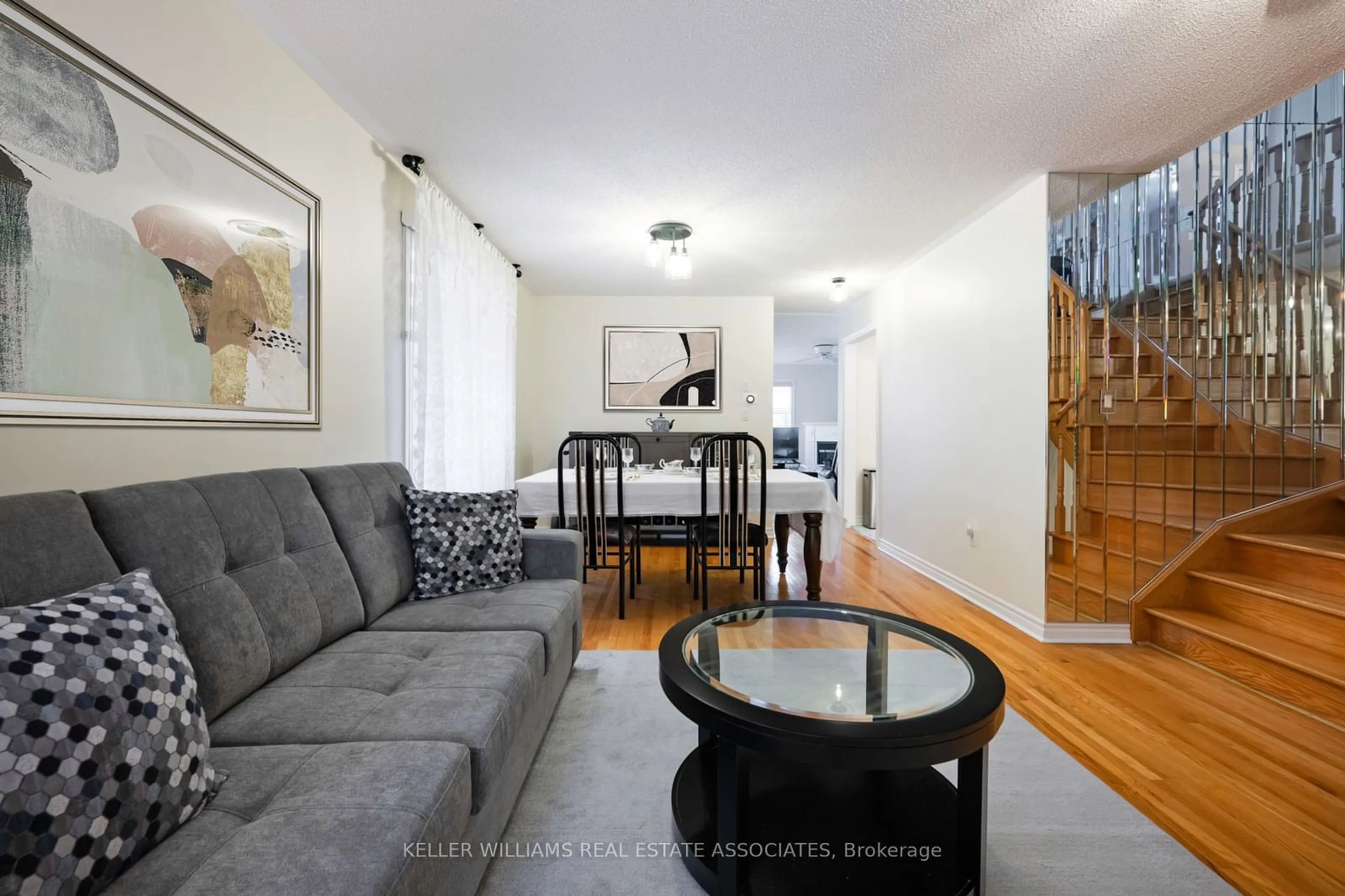 Living room with furniture, wood/laminate floor for 728 Spanish Moss Tr, Mississauga Ontario L5W 1E6