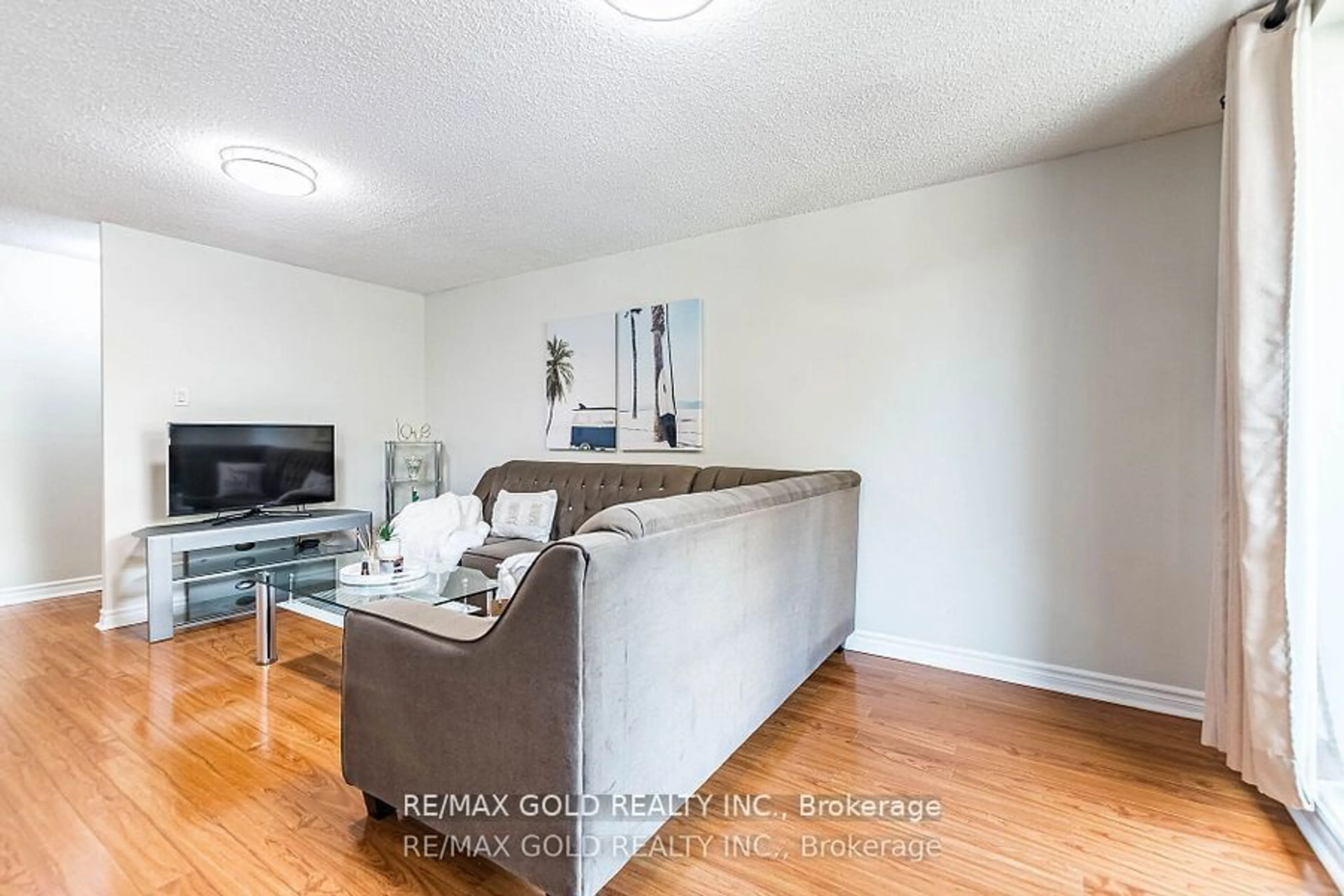 Living room with furniture, wood/laminate floor for 3555 Derry Rd #209, Mississauga Ontario L4T 1B2