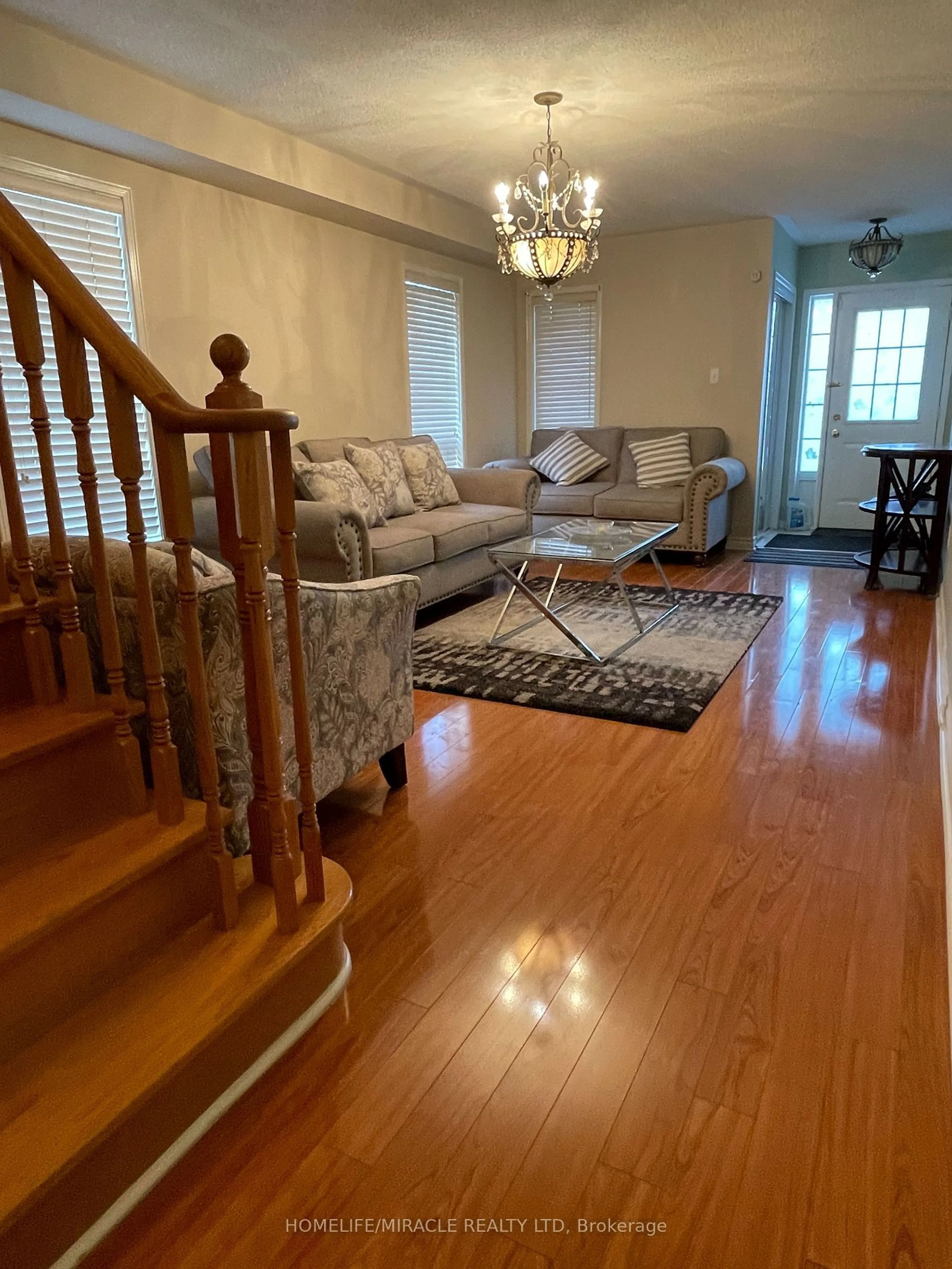 Living room with furniture, wood/laminate floor for 26 Penbridge Circ, Brampton Ontario L7A 2P9