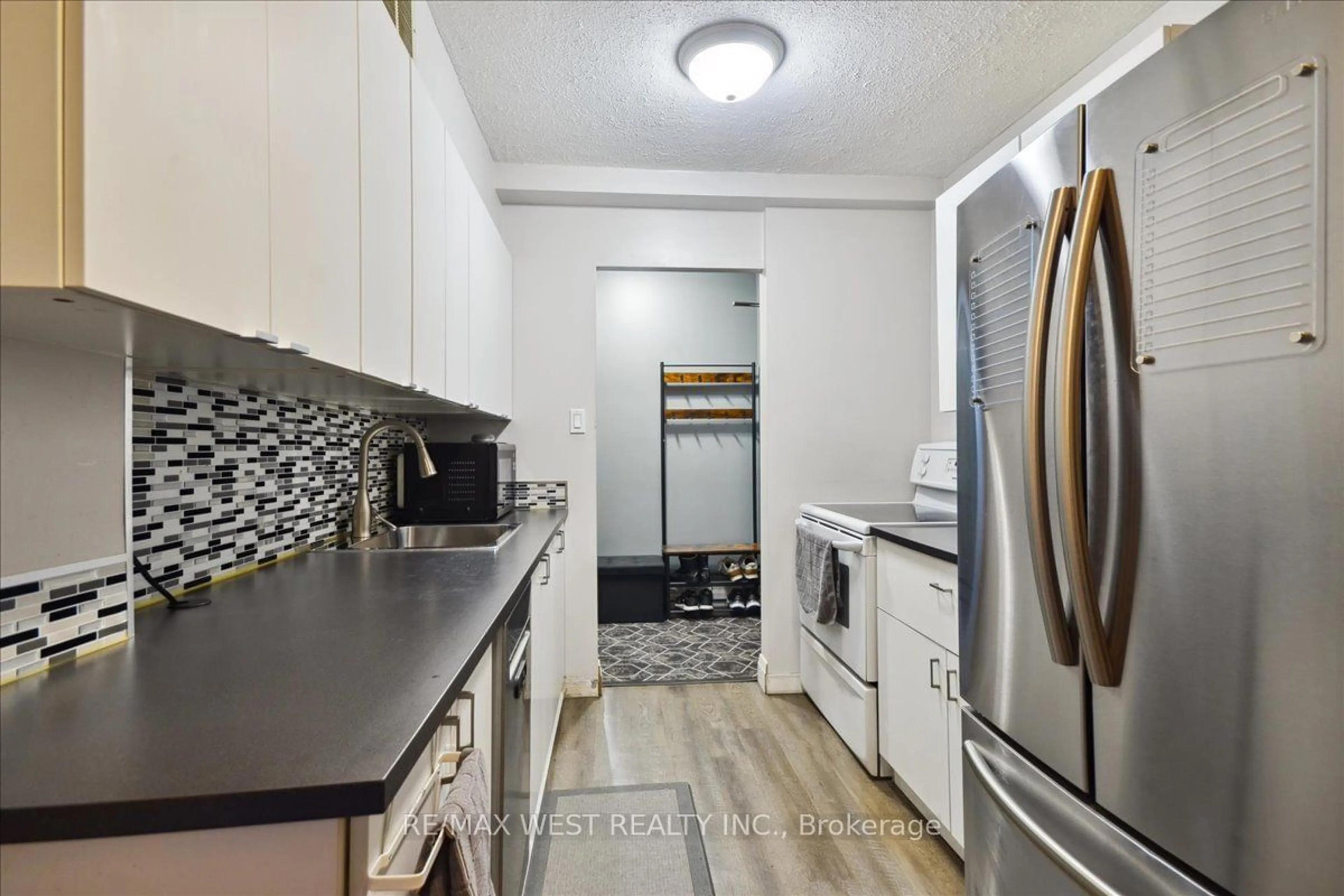 Kitchen with laundary machines, ceramic/tile floor for 340 Dixon Rd #1105, Toronto Ontario M9R 1T1