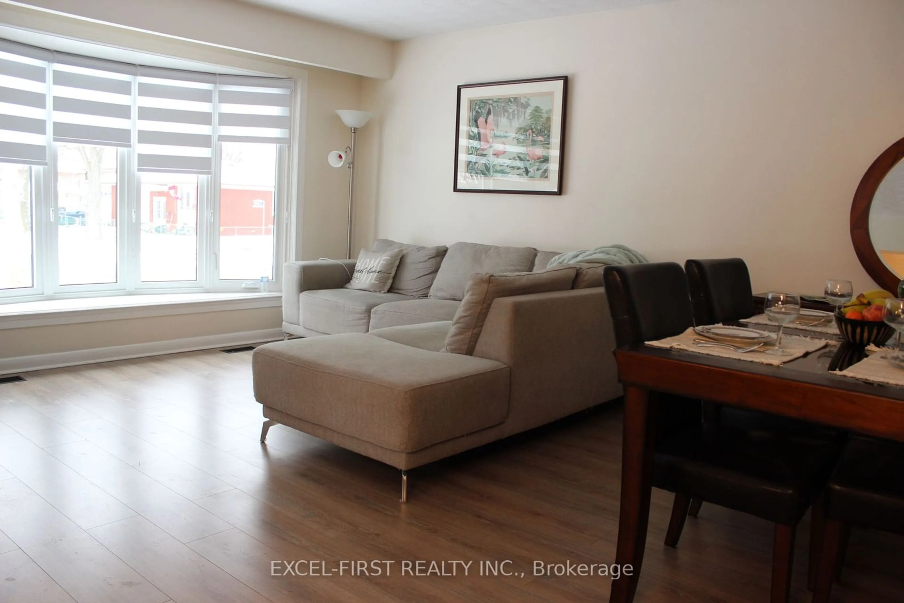 Living room with furniture, wood/laminate floor for 215 Thistle Down Blvd, Toronto Ontario M9V 1K4