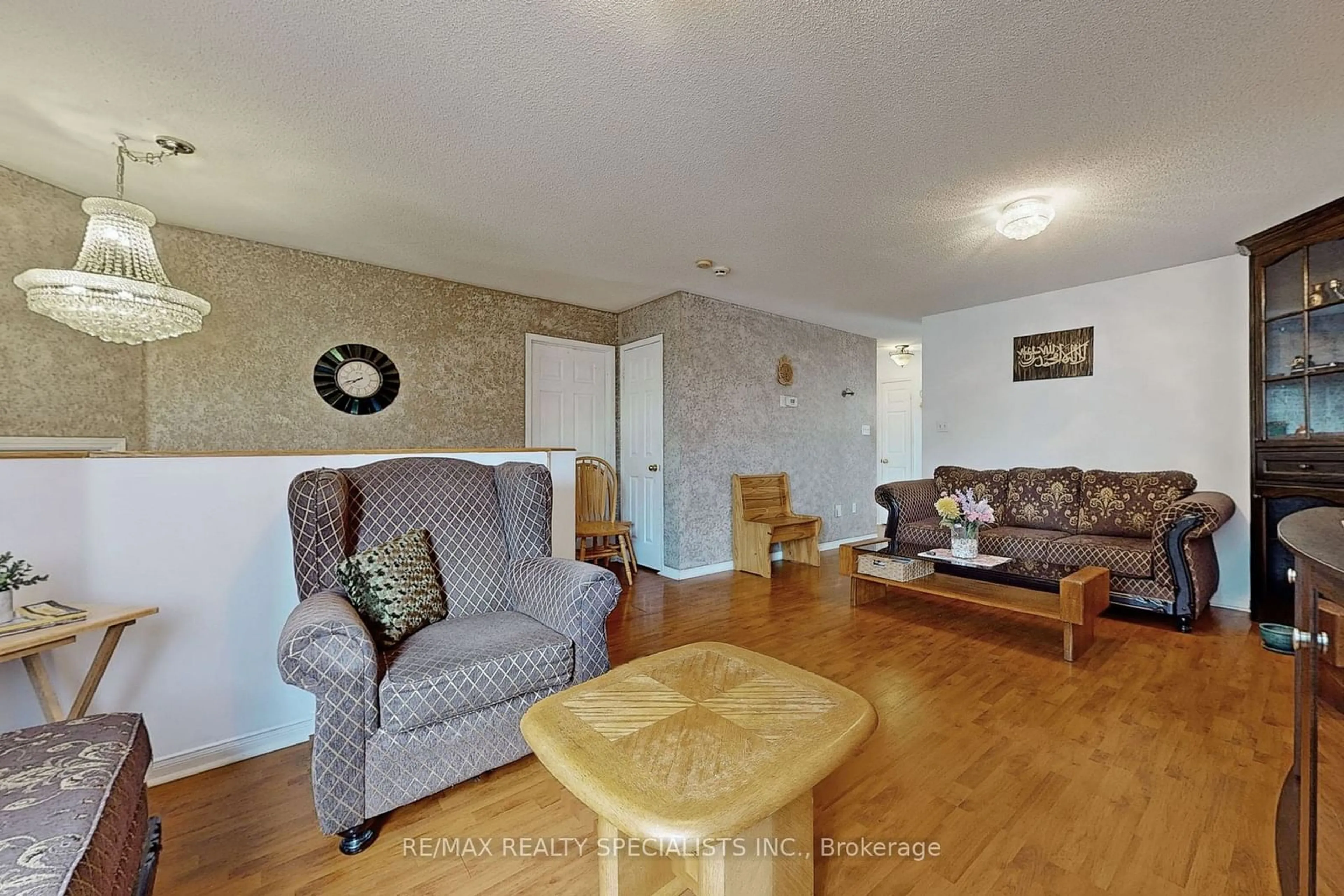 Living room with furniture, wood/laminate floor for 69 Red Maple Dr, Brampton Ontario L6X 4M1