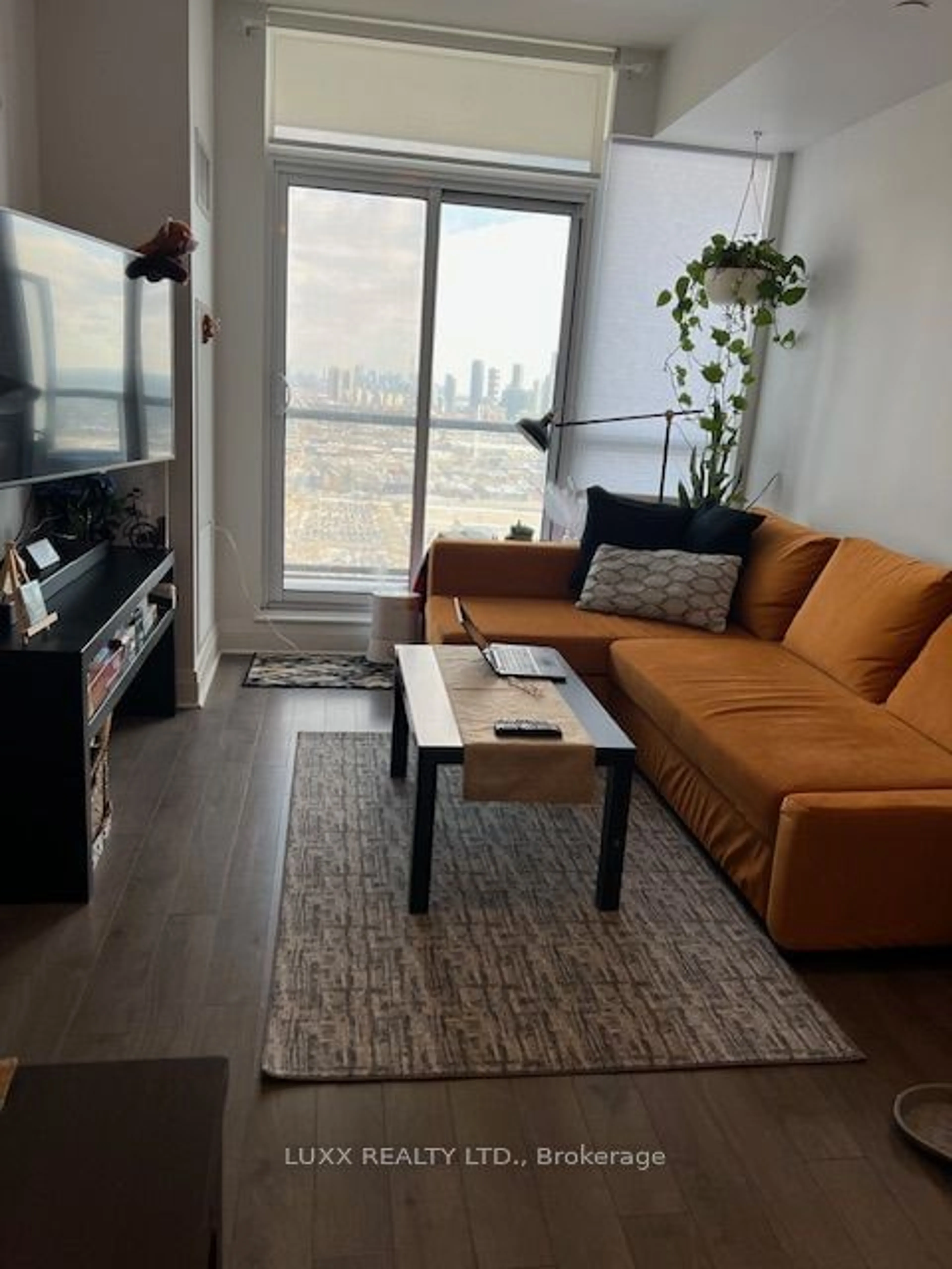 Living room with furniture, wood/laminate floor for 17 Zorra St #1904, Toronto Ontario M8Z 0C8