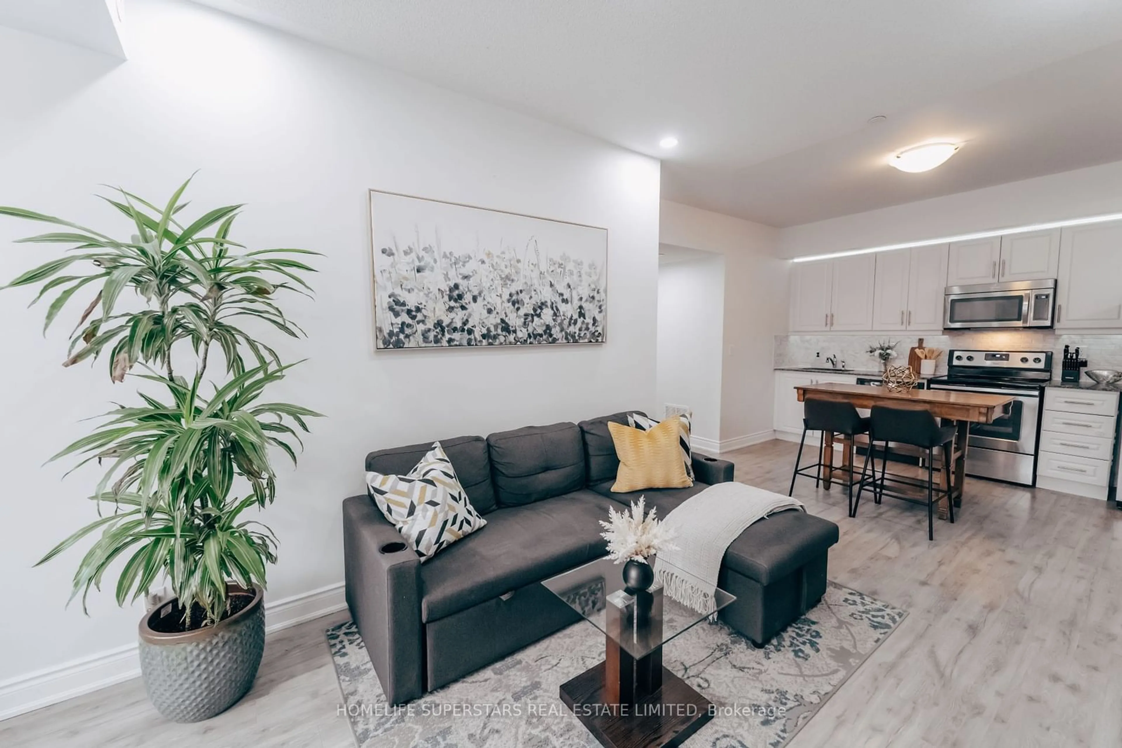 Living room with furniture, wood/laminate floor for 120 Twenty Fourth St #25, Toronto Ontario M8V 0B9