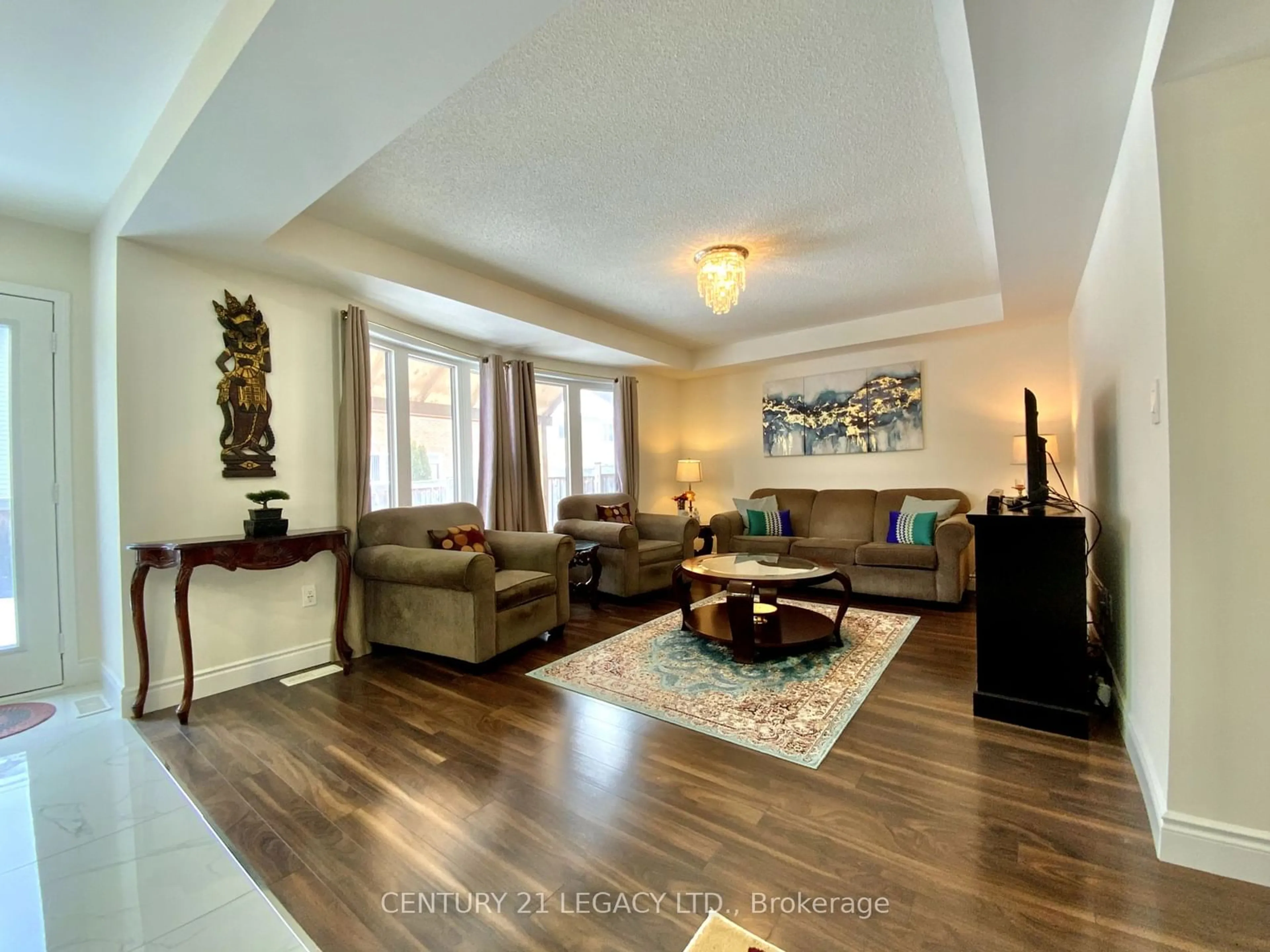 Living room with furniture, wood/laminate floor for 35 Donomore Dr, Brampton Ontario L7A 0S2