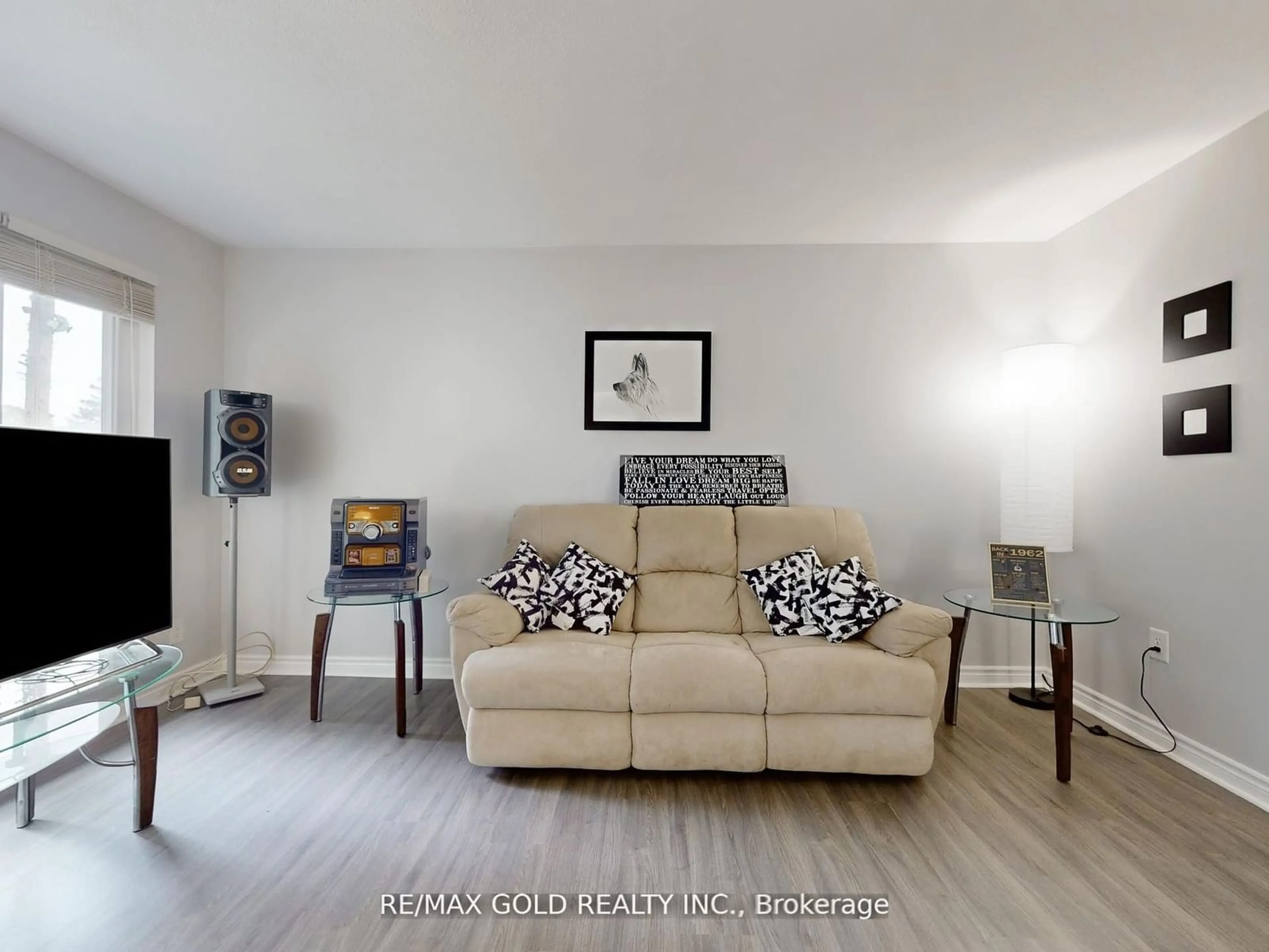 Living room with furniture, wood/laminate floor for 44 Deloraine Dr, Brampton Ontario L6T 1T7