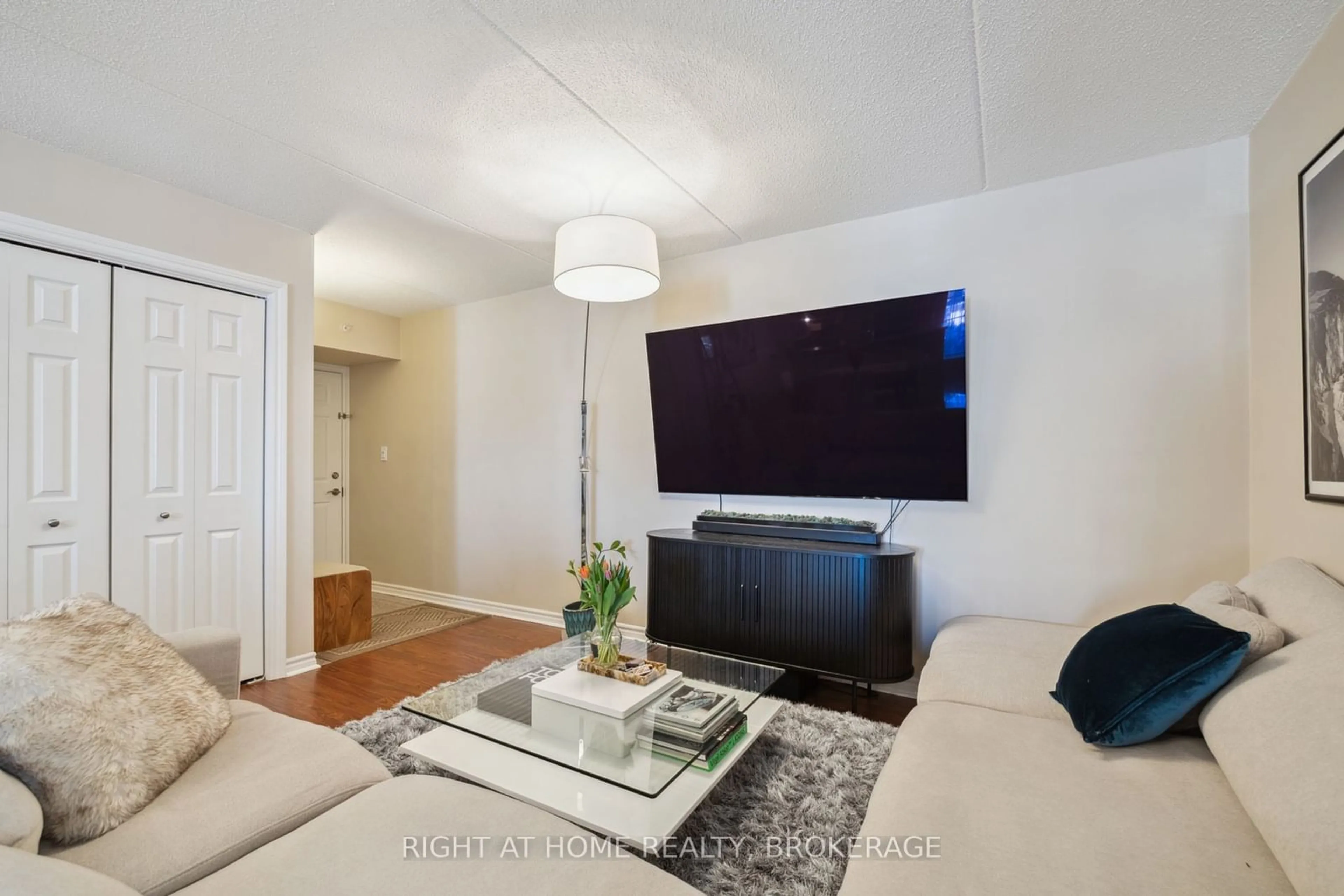 Living room with furniture, wood/laminate floor for 1460 Bishops Gate #202, Oakville Ontario L6M 4N5