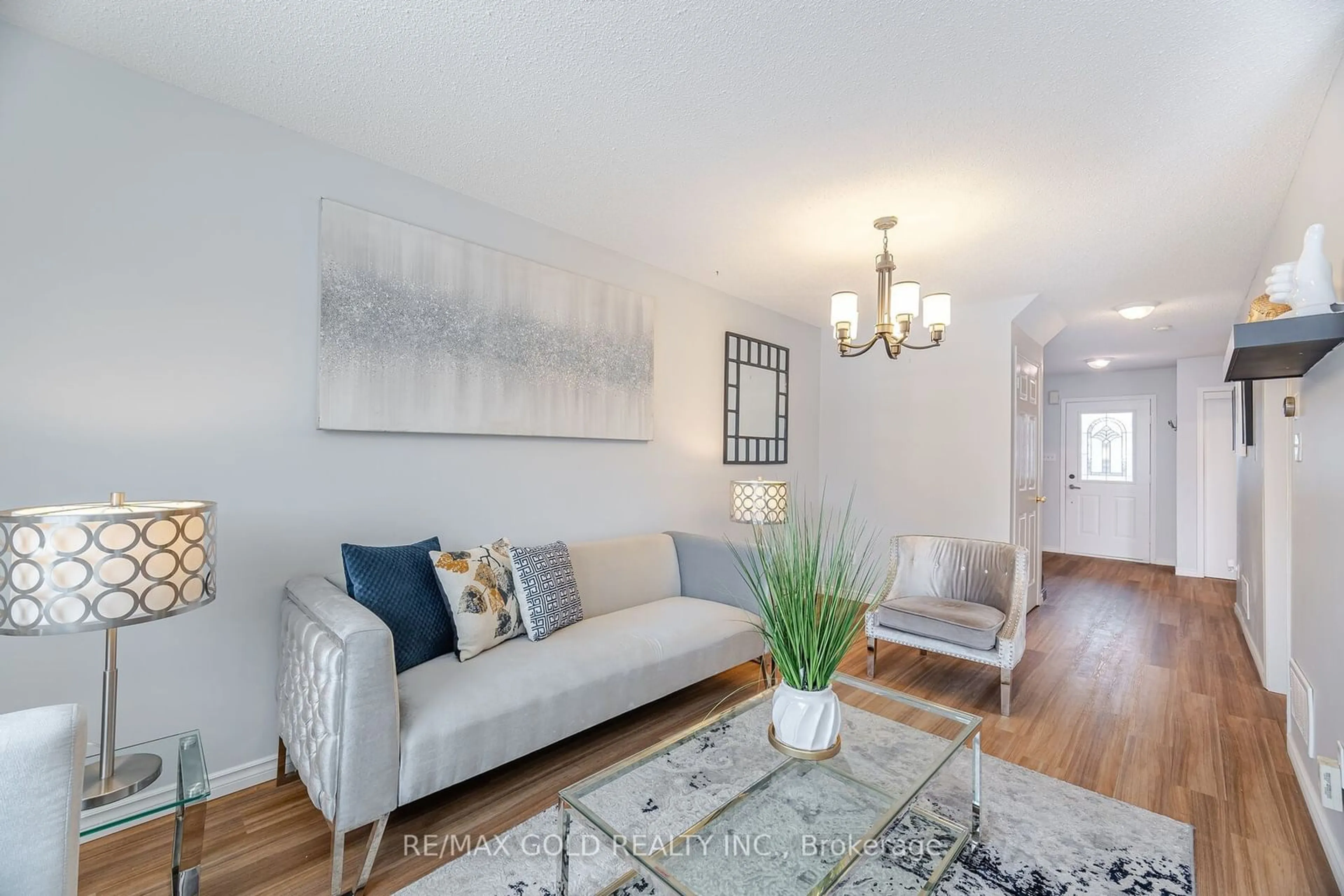 Living room with furniture, wood/laminate floor for 69 White Tail Cres, Brampton Ontario L6Y 5C1