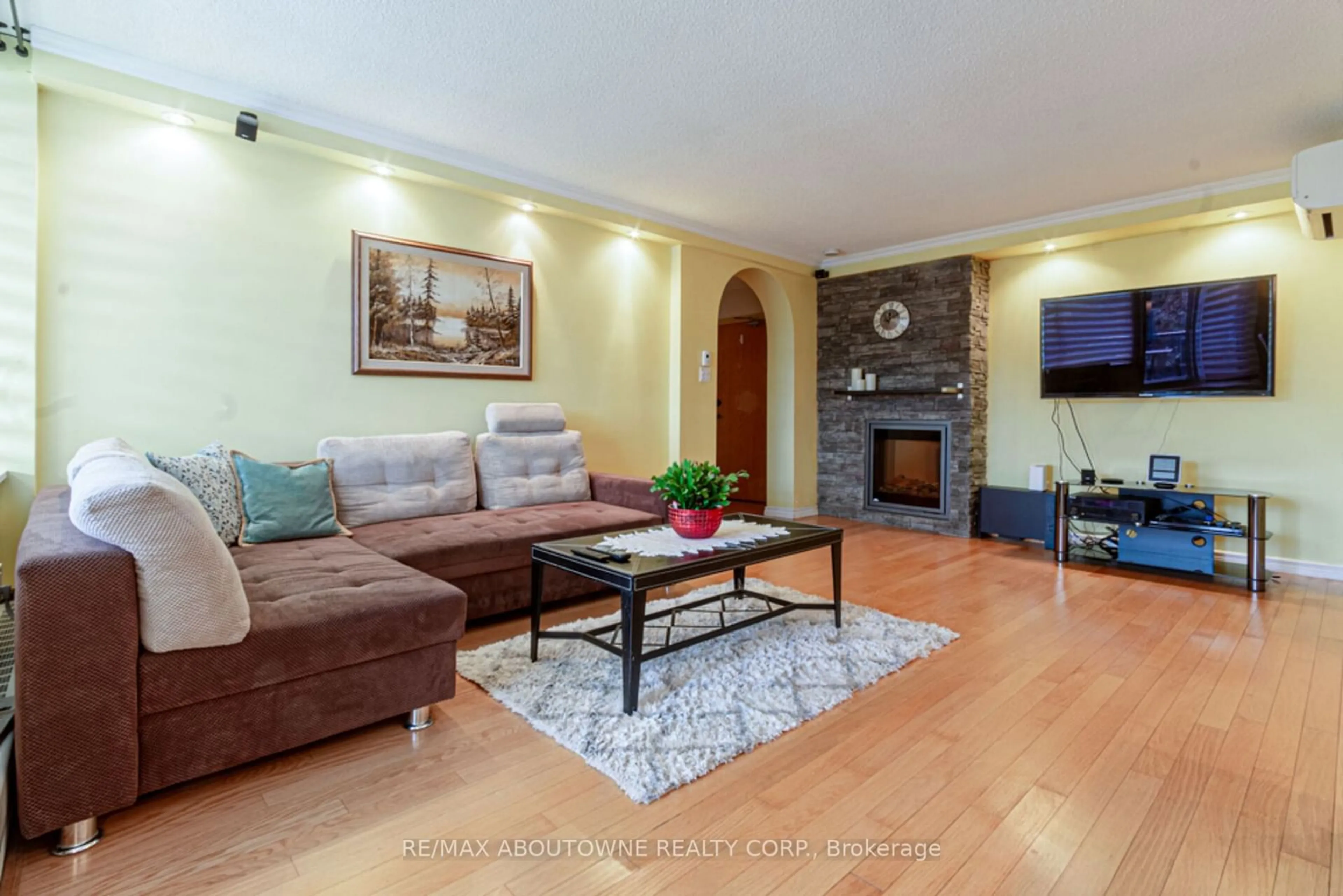 Living room with furniture, wood/laminate floor for 420 Mill Rd #408, Toronto Ontario M9C 1Z1