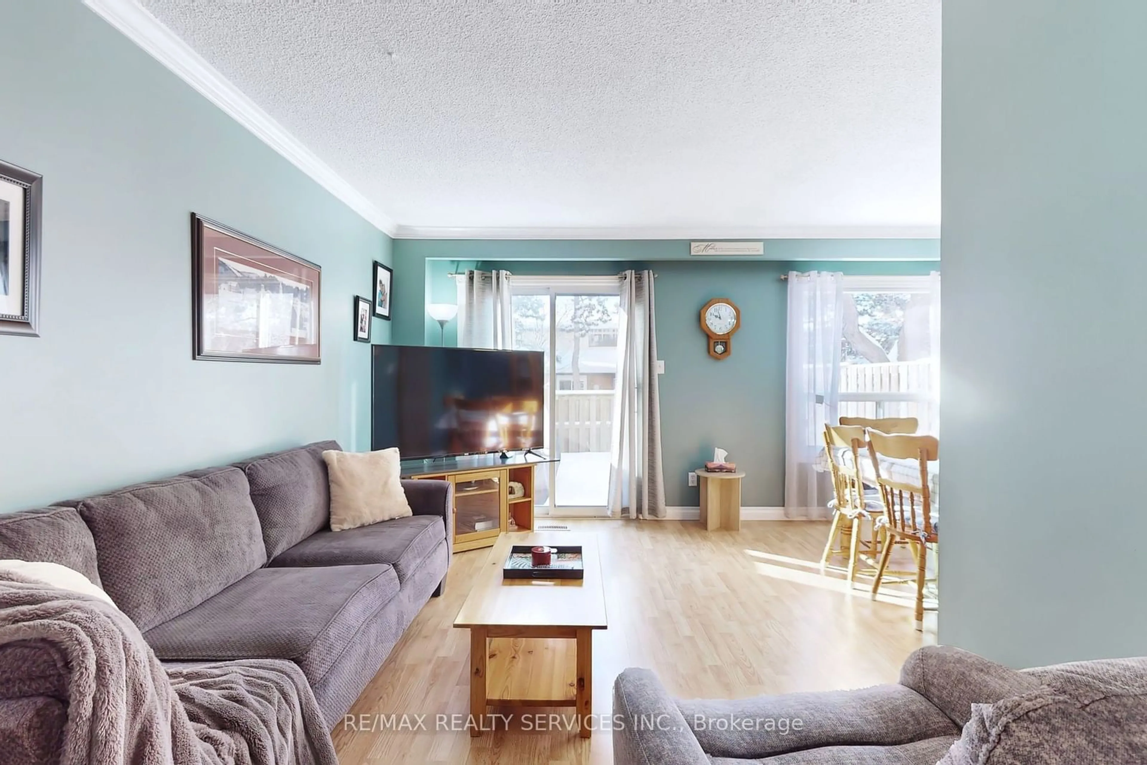 Living room with furniture, wood/laminate floor for 3 Collins Cres, Brampton Ontario L6V 3M9