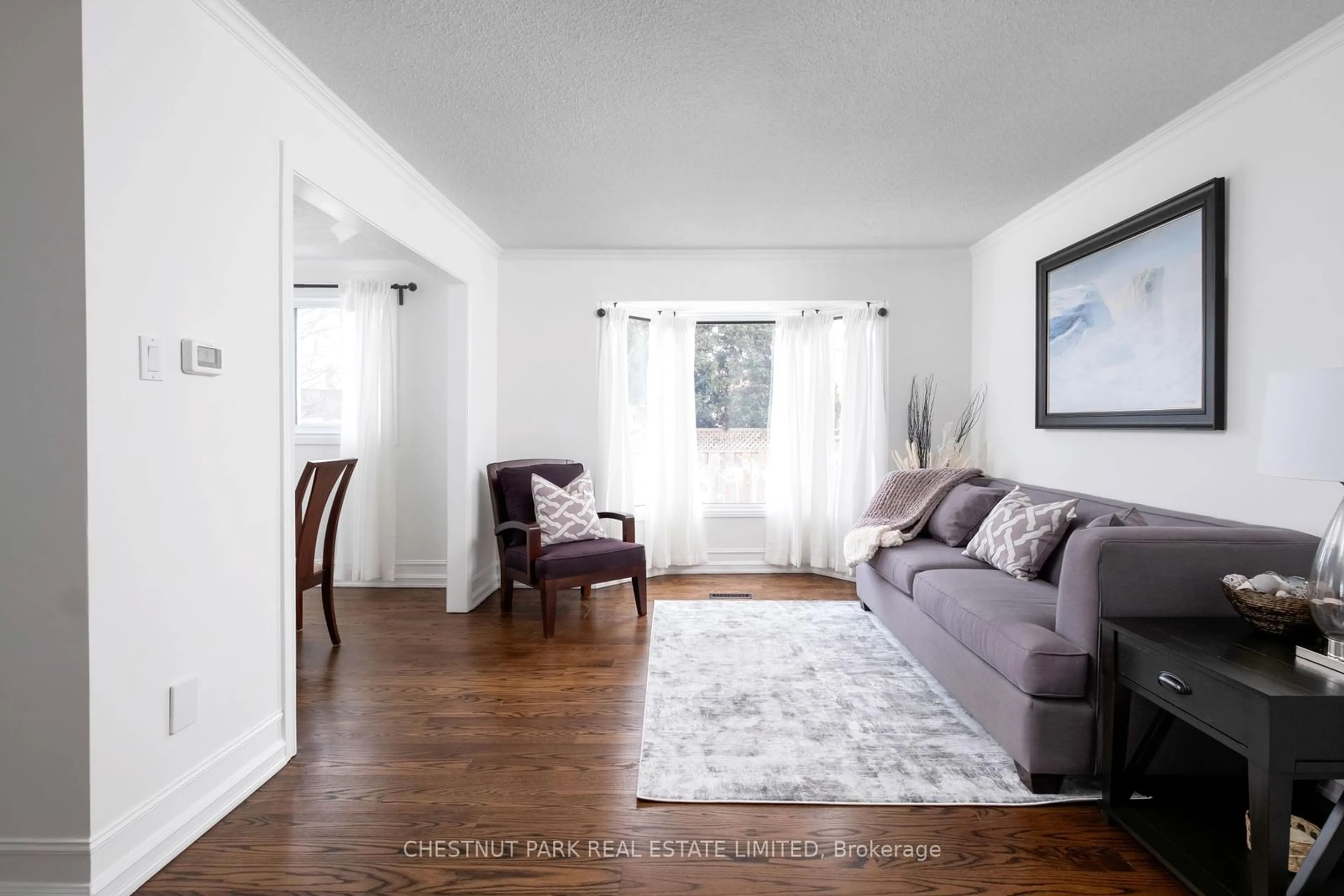 Living room with furniture, wood/laminate floor for 82 Philosopher's Tr, Brampton Ontario L6S 4C9