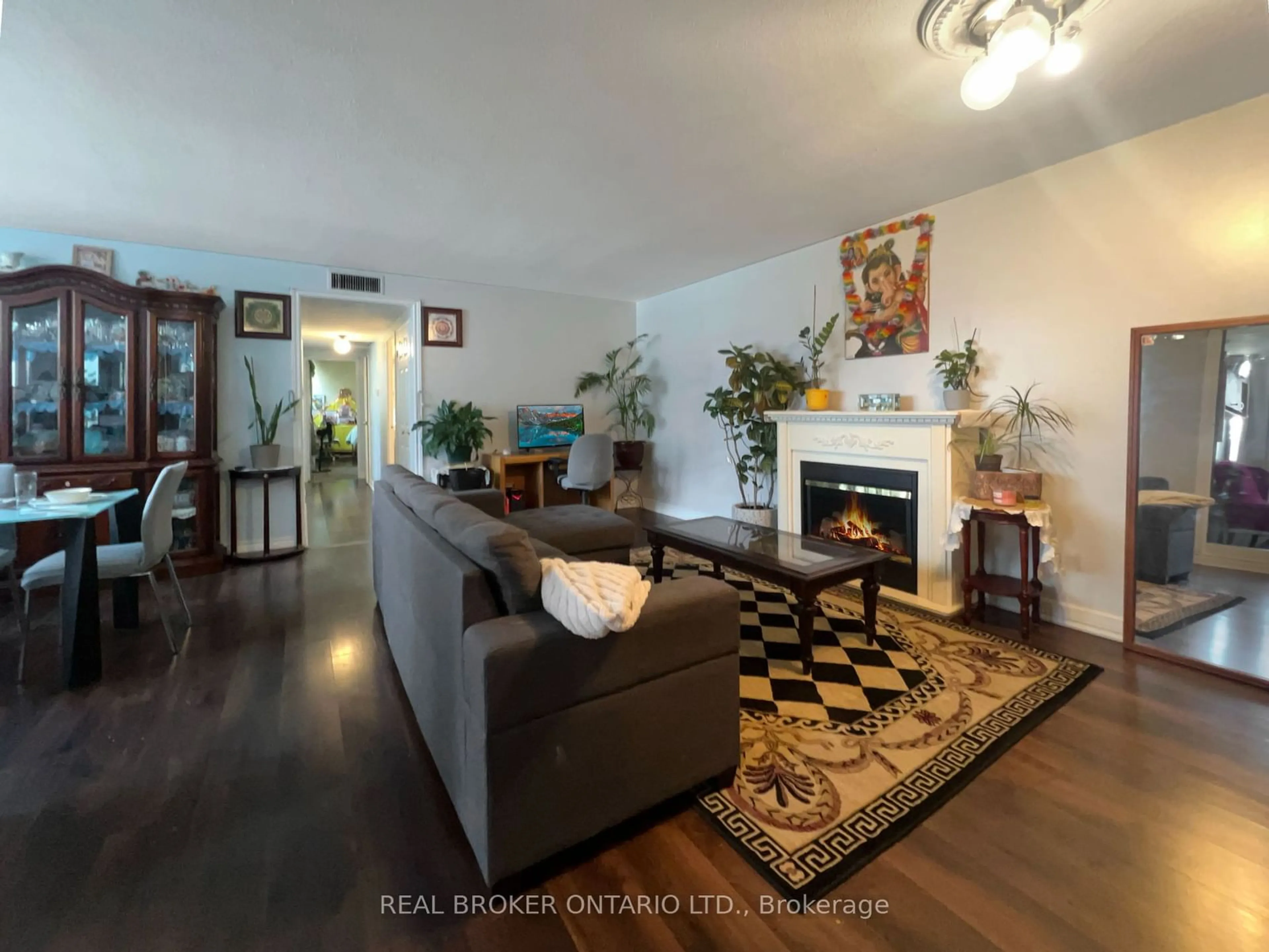 Living room with furniture, wood/laminate floor for 2323 Confederation Pkwy #206, Mississauga Ontario L5B 1R6