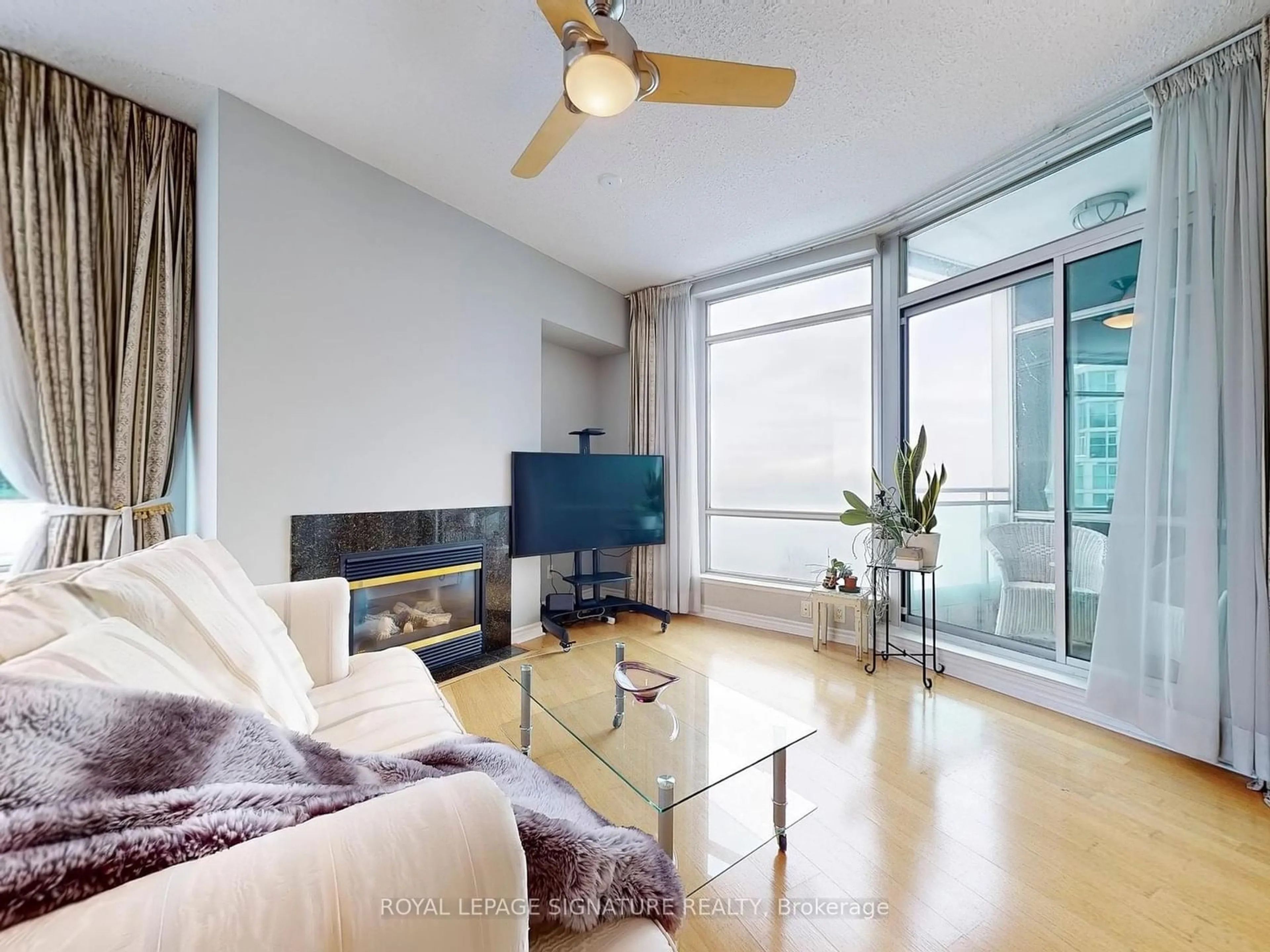 Living room with furniture, wood/laminate floor for 5 Marine Parade Dr #1014, Toronto Ontario M8V 4B4