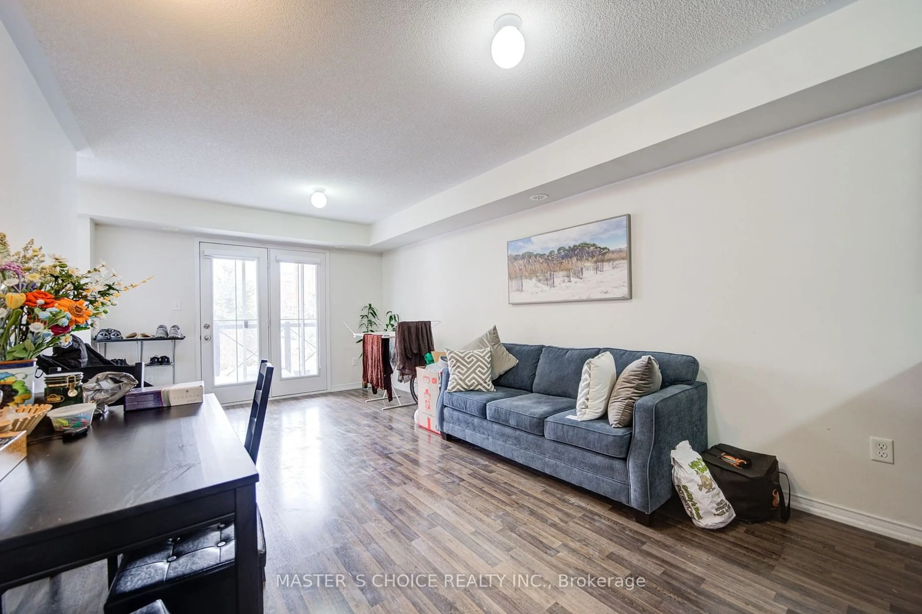 Living room with furniture, wood/laminate floor for 2500 Post Rd #14, Oakville Ontario L6H 0K1