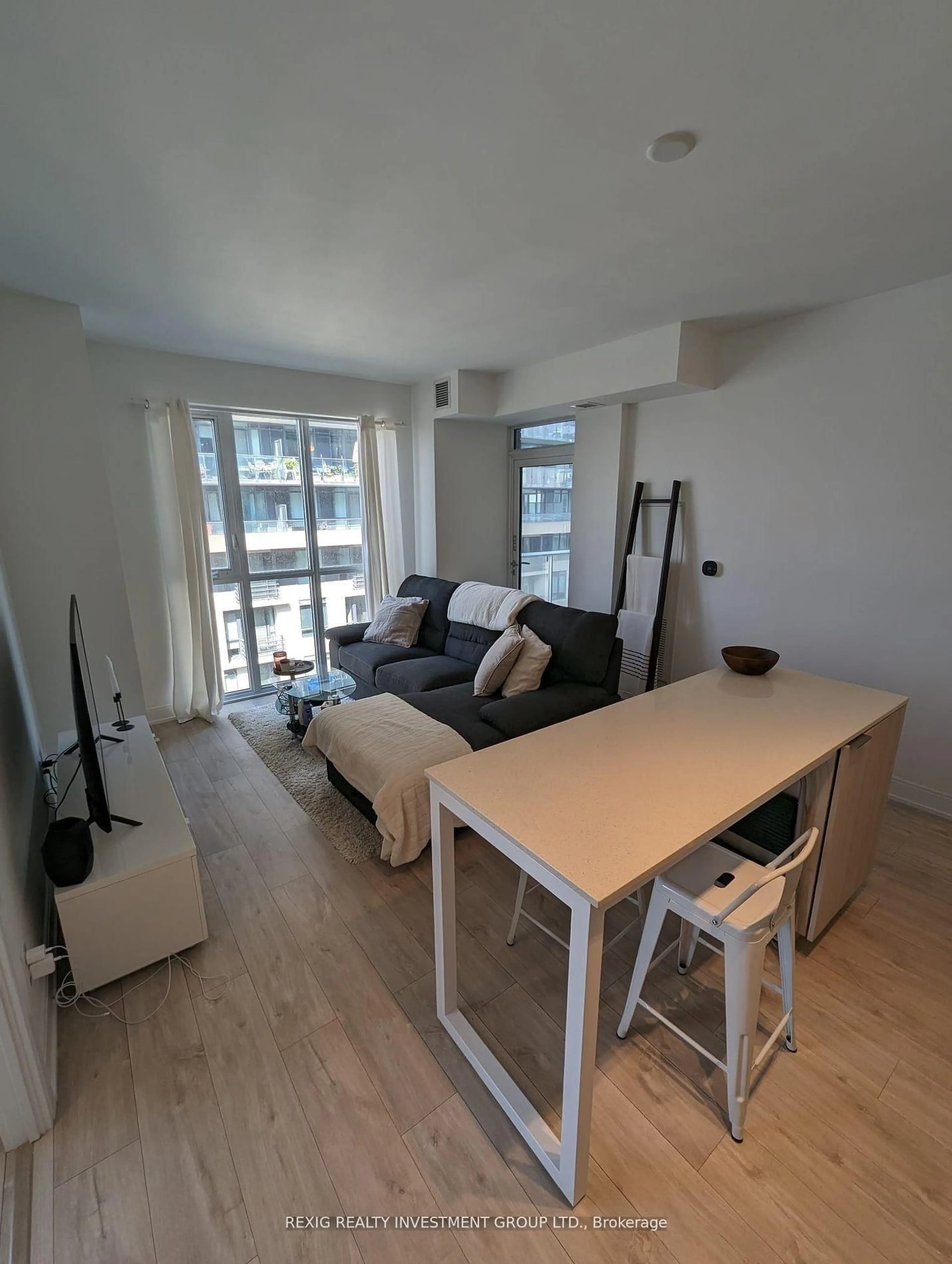 Living room with furniture, wood/laminate floor for 70 Annie Craig Dr #304, Toronto Ontario M8V 0C4