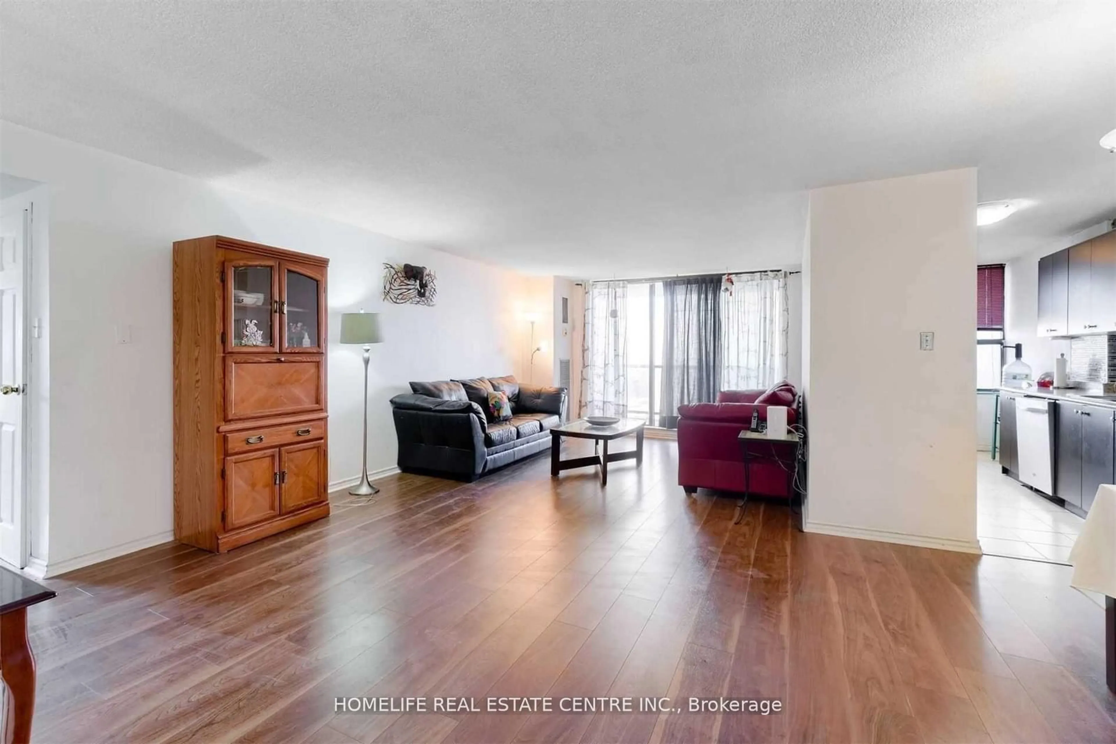 Living room with furniture, wood/laminate floor for 21 Knightsbridge Rd #1210, Brampton Ontario L6T 3Y1