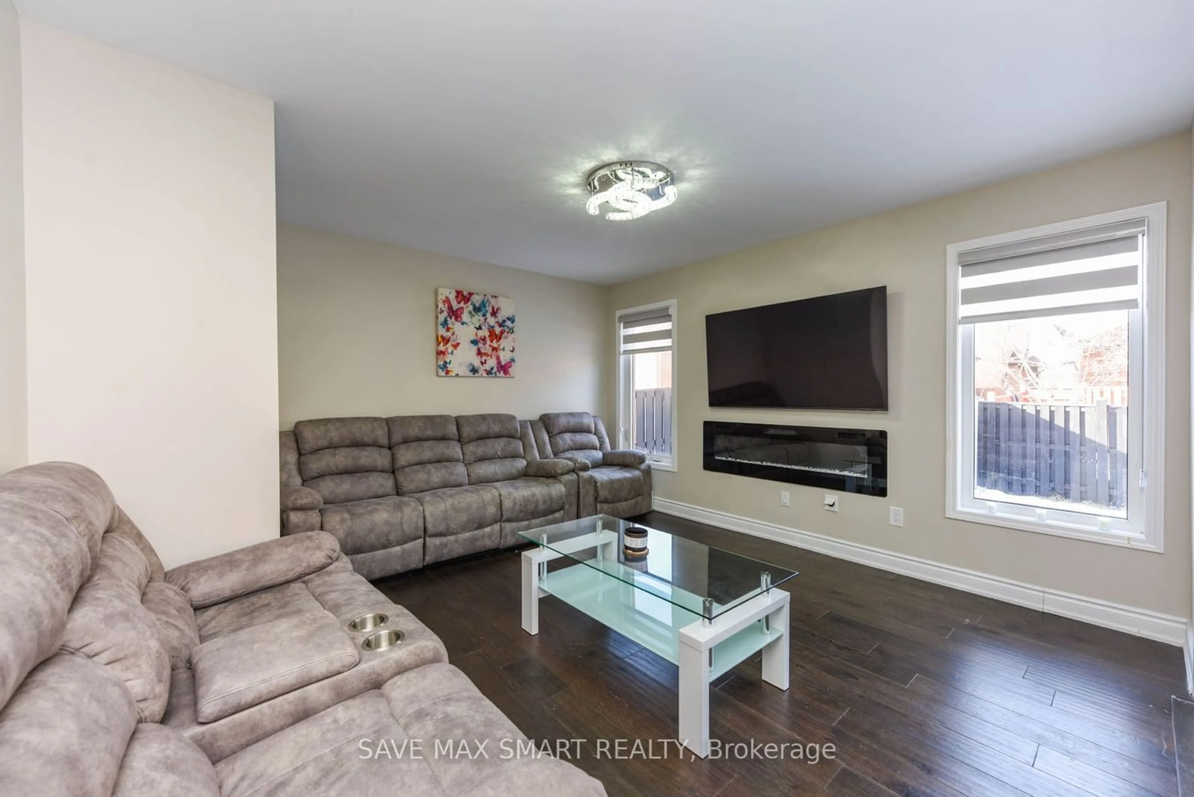 Living room with furniture, wood/laminate floor for 54 Beresford Cres, Brampton Ontario L6P 2M1