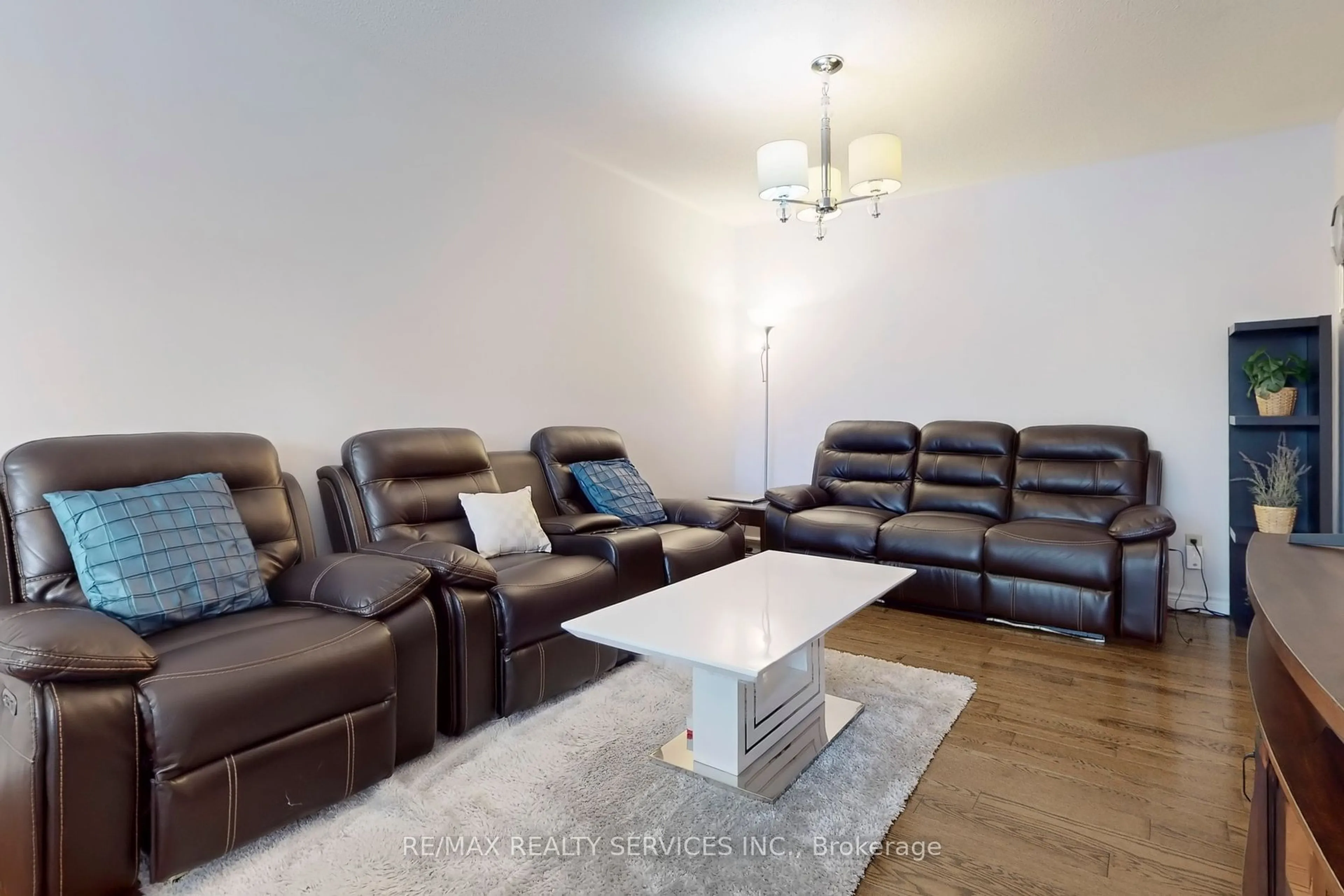 Living room with furniture, wood/laminate floor for 28 Heathcliffe Sq, Brampton Ontario L6S 5P7