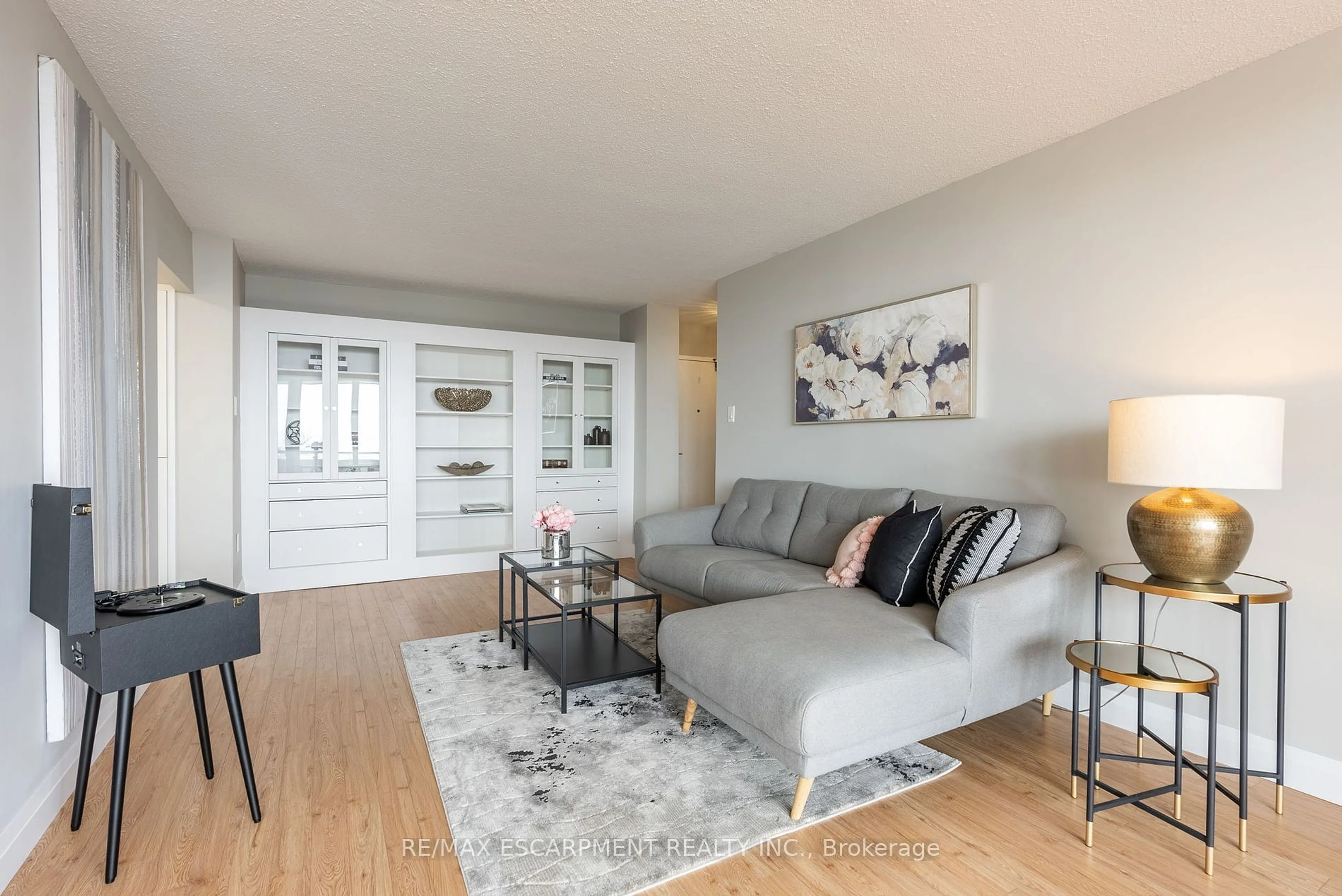 Living room with furniture, wood/laminate floor for 2055 Upper Middle Rd #306, Burlington Ontario L7P 3P4