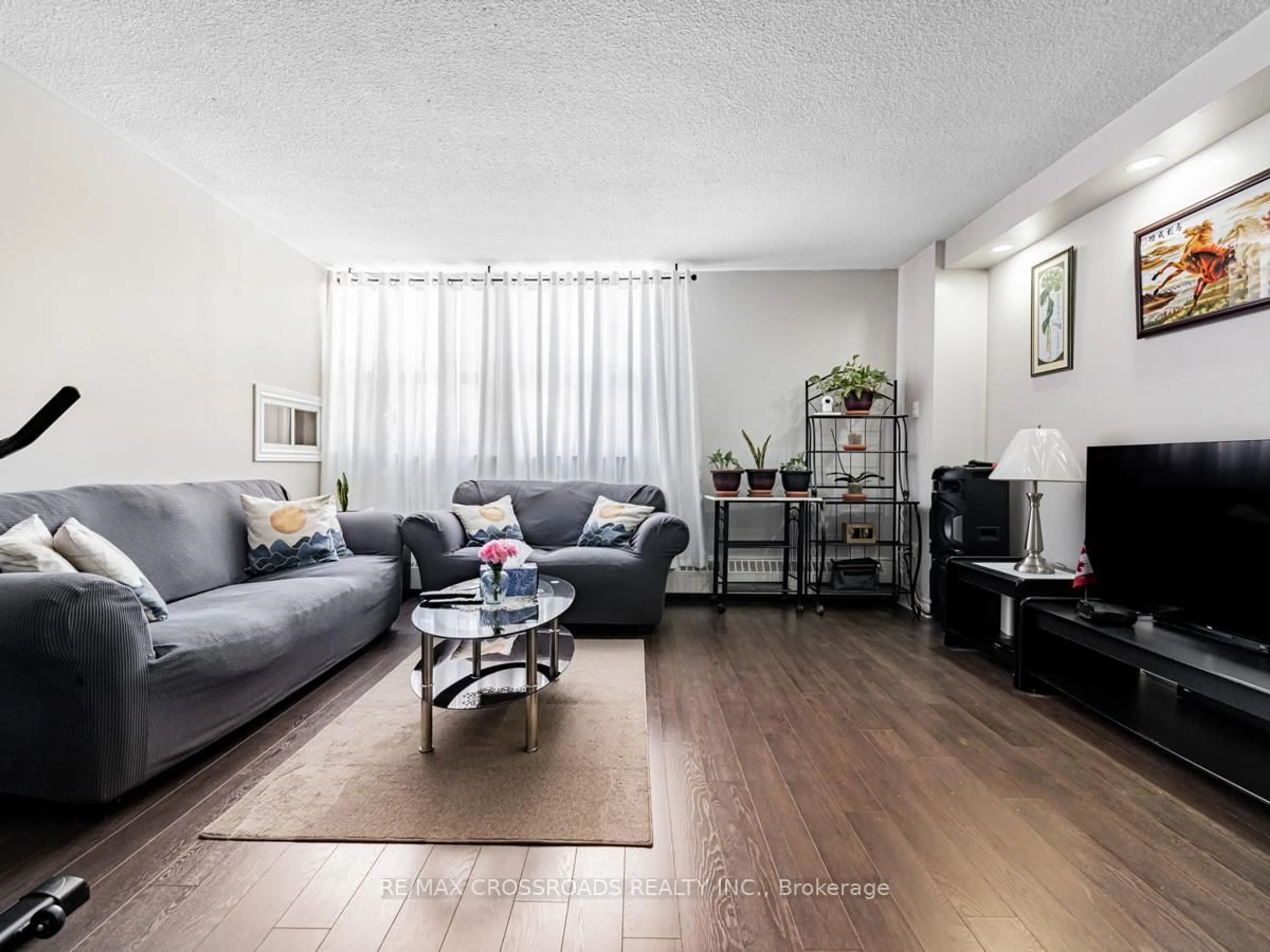 Living room with furniture, wood/laminate floor for 2645 Kipling Ave #101, Toronto Ontario M9V 3S6