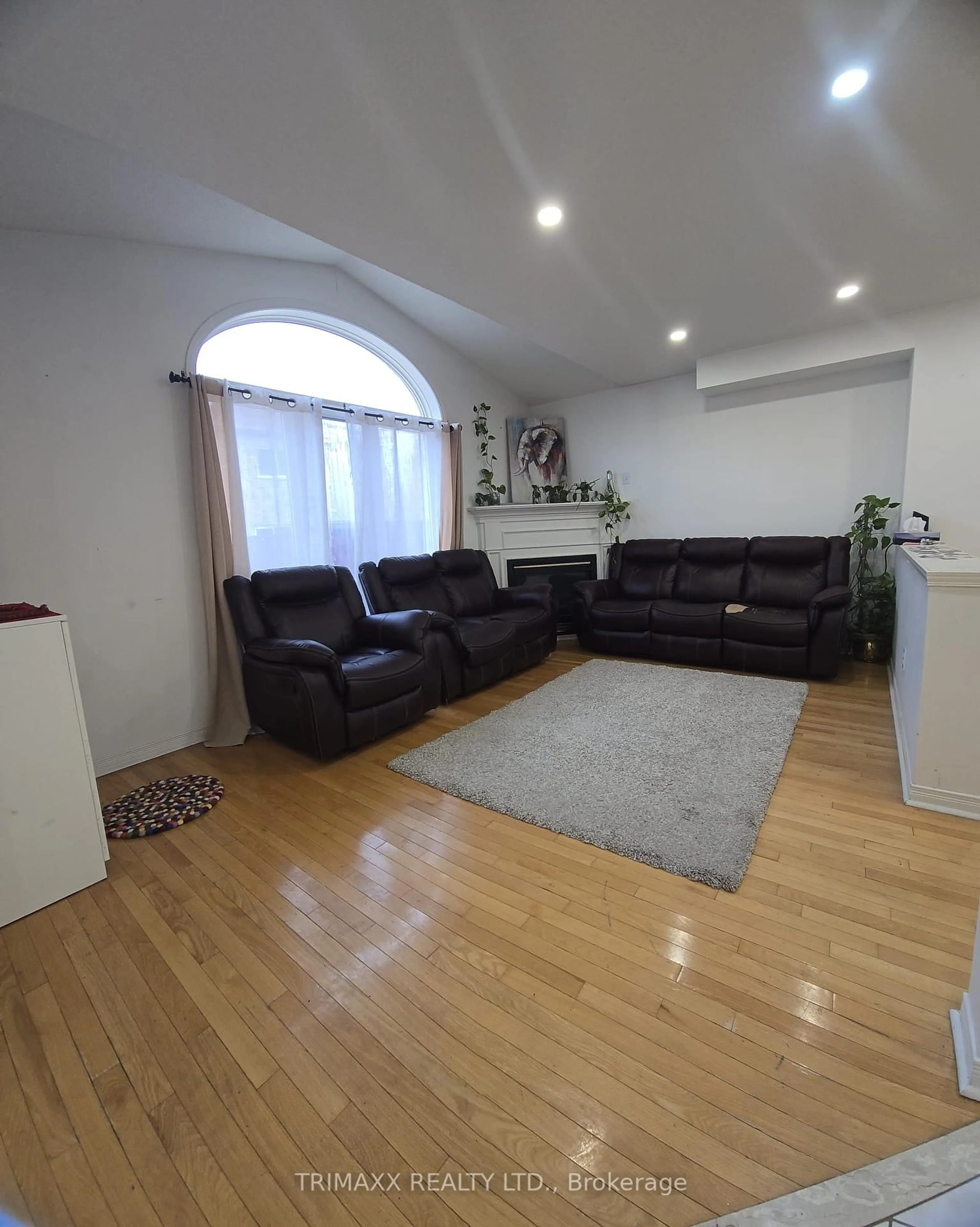 Living room with furniture, wood/laminate floor for 87 Heartleaf Cres, Brampton Ontario L7A 2B9