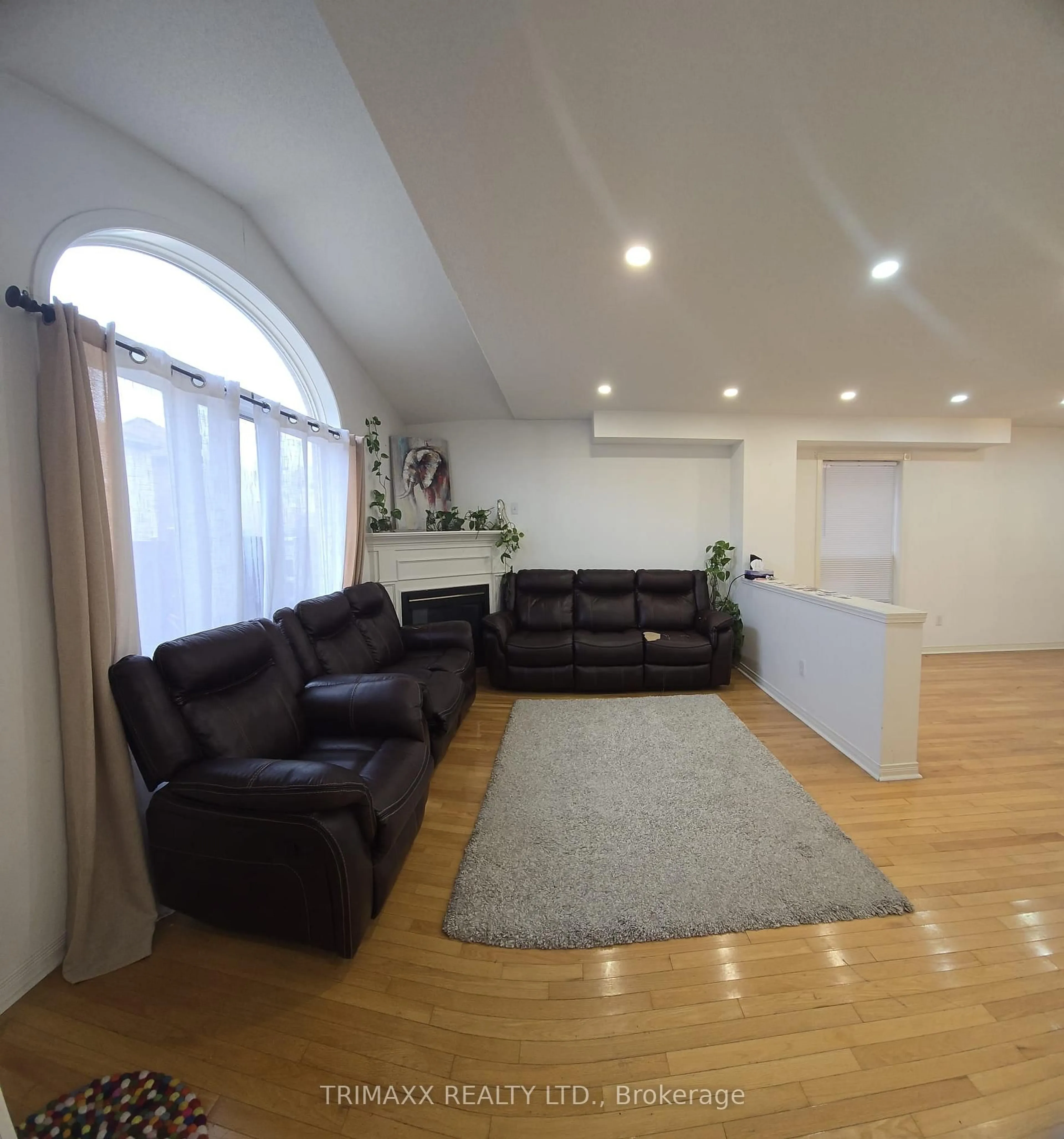 Living room with furniture, wood/laminate floor for 87 Heartleaf Cres, Brampton Ontario L7A 2B9