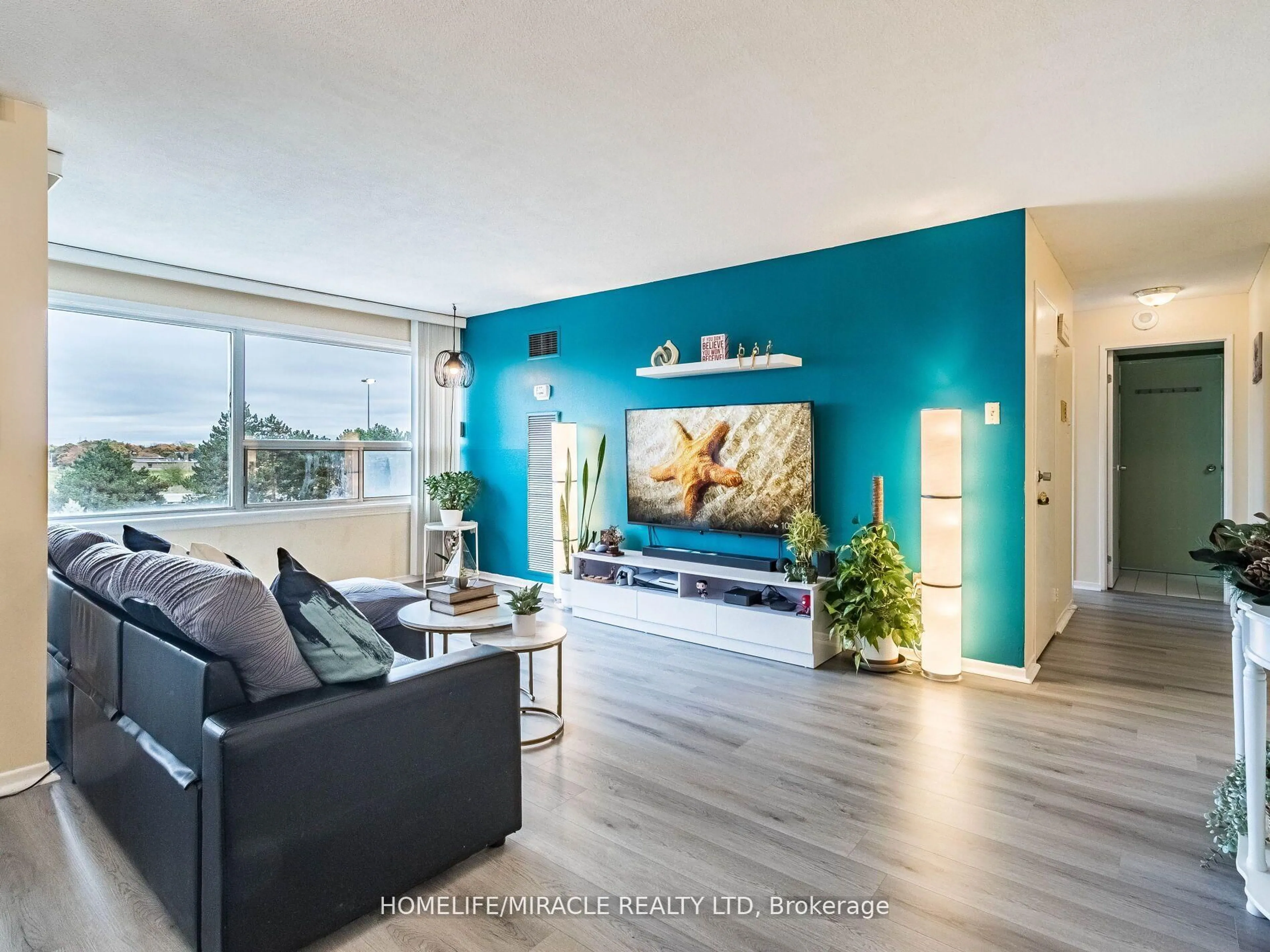 Living room with furniture, wood/laminate floor for 475 The West Mall #510, Toronto Ontario M9C 4Z3