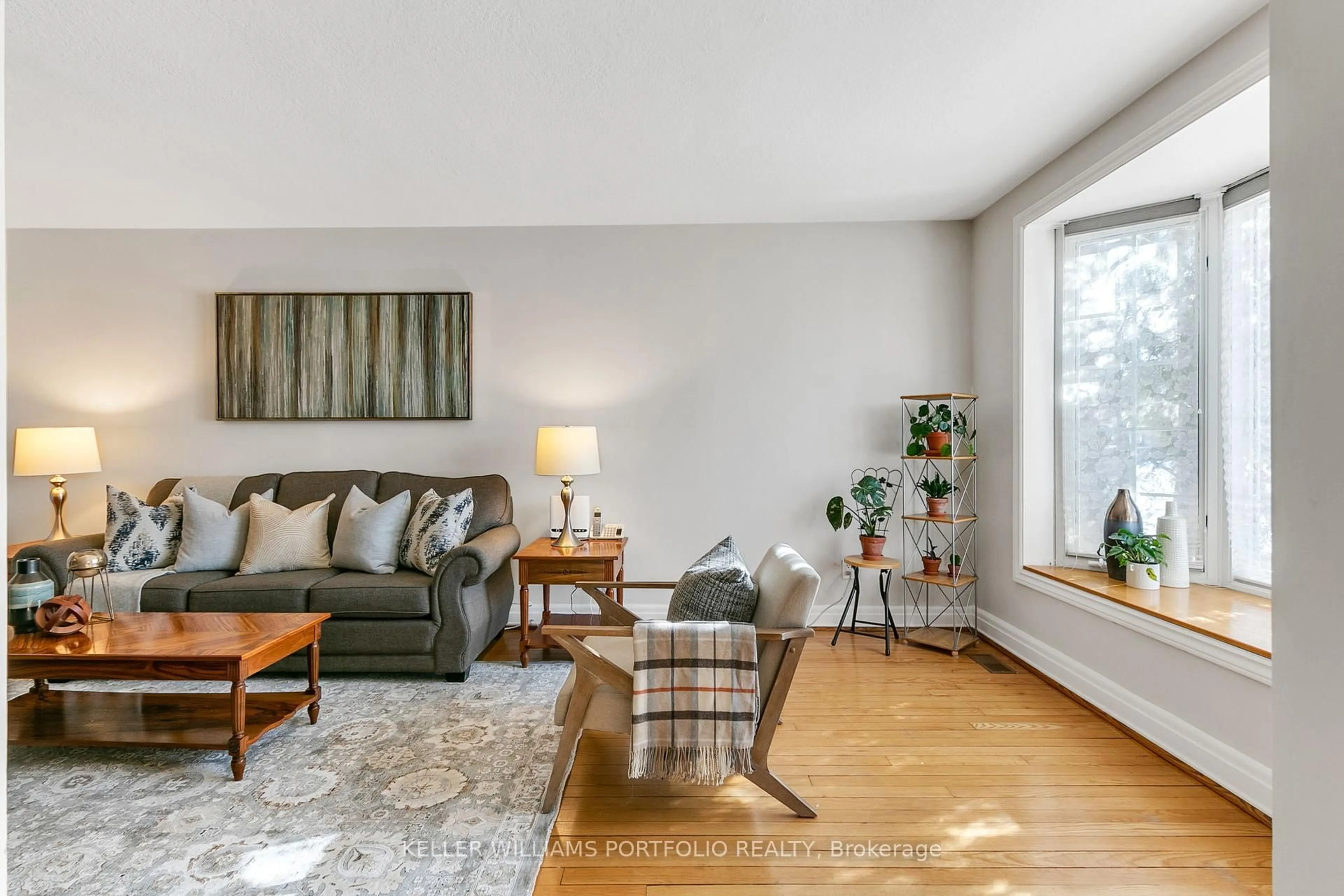 Living room with furniture, wood/laminate floor for 111 Ashbourne Dr, Toronto Ontario M9B 4H6