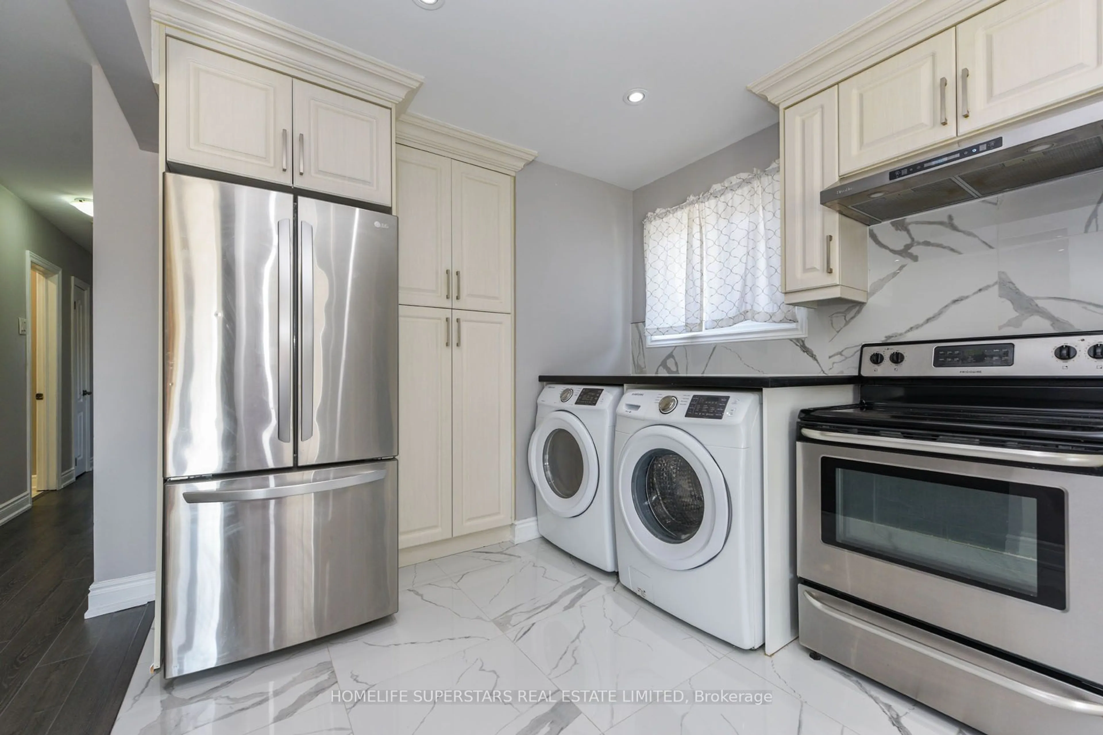 Kitchen with laundary machines, ceramic/tile floor for 76 Flowertown Ave, Brampton Ontario L6X 2K7