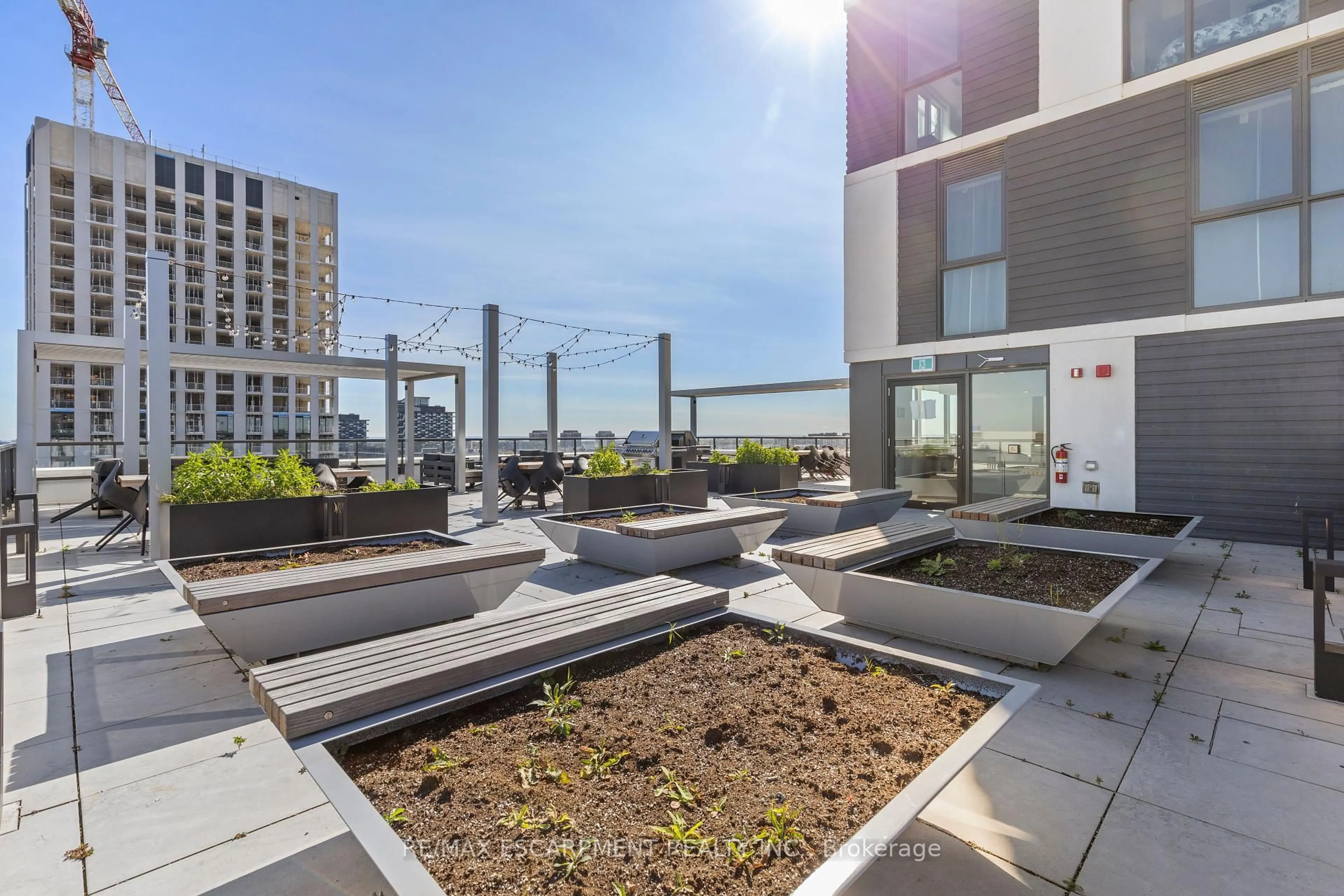 Patio, city buildings view from balcony for 335 Wheat Boom Dr #418, Oakville Ontario L6H 7Y1