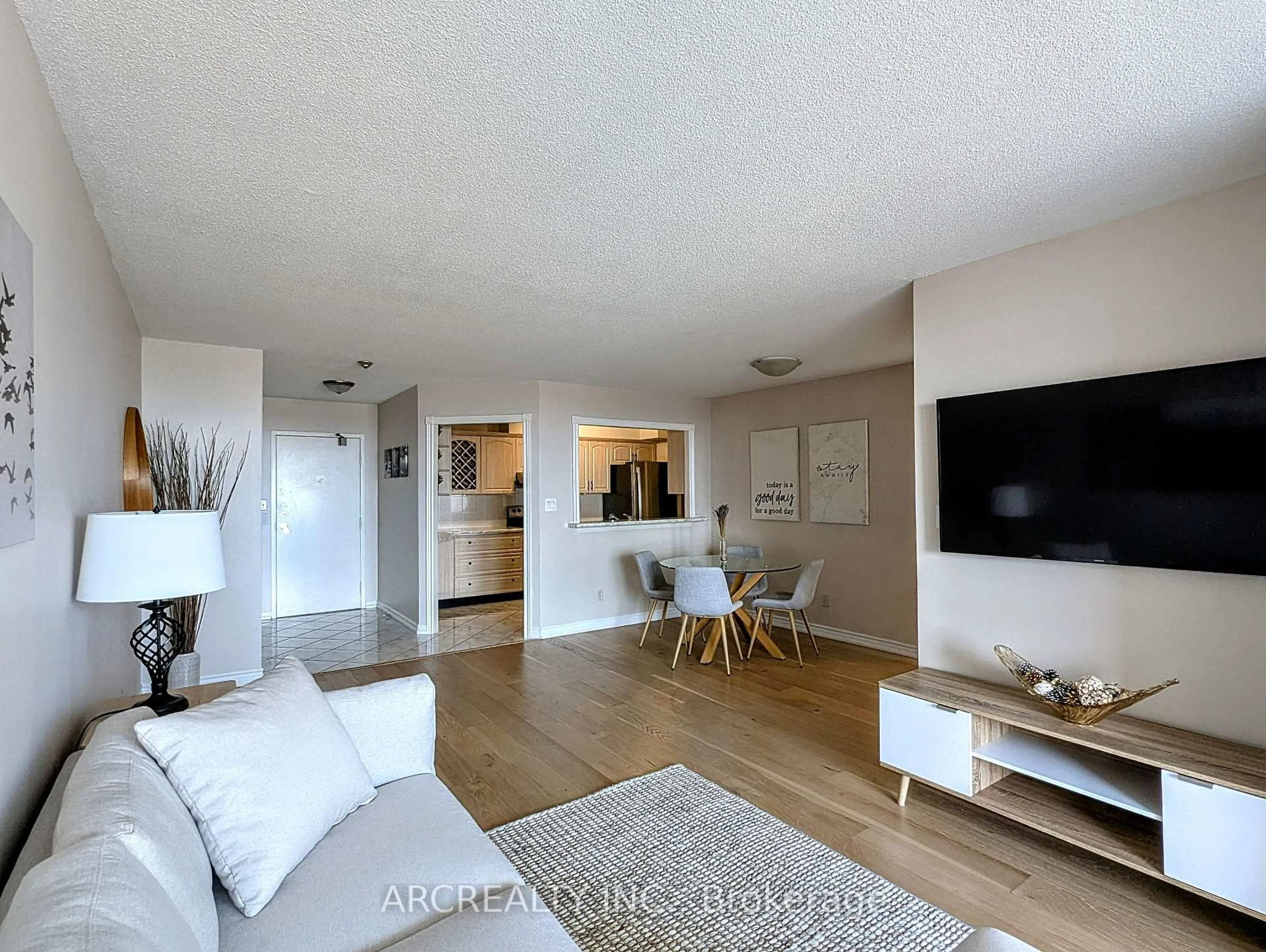 Living room with furniture, wood/laminate floor for 3605 Kariya Dr #2311, Mississauga Ontario L5B 3J2