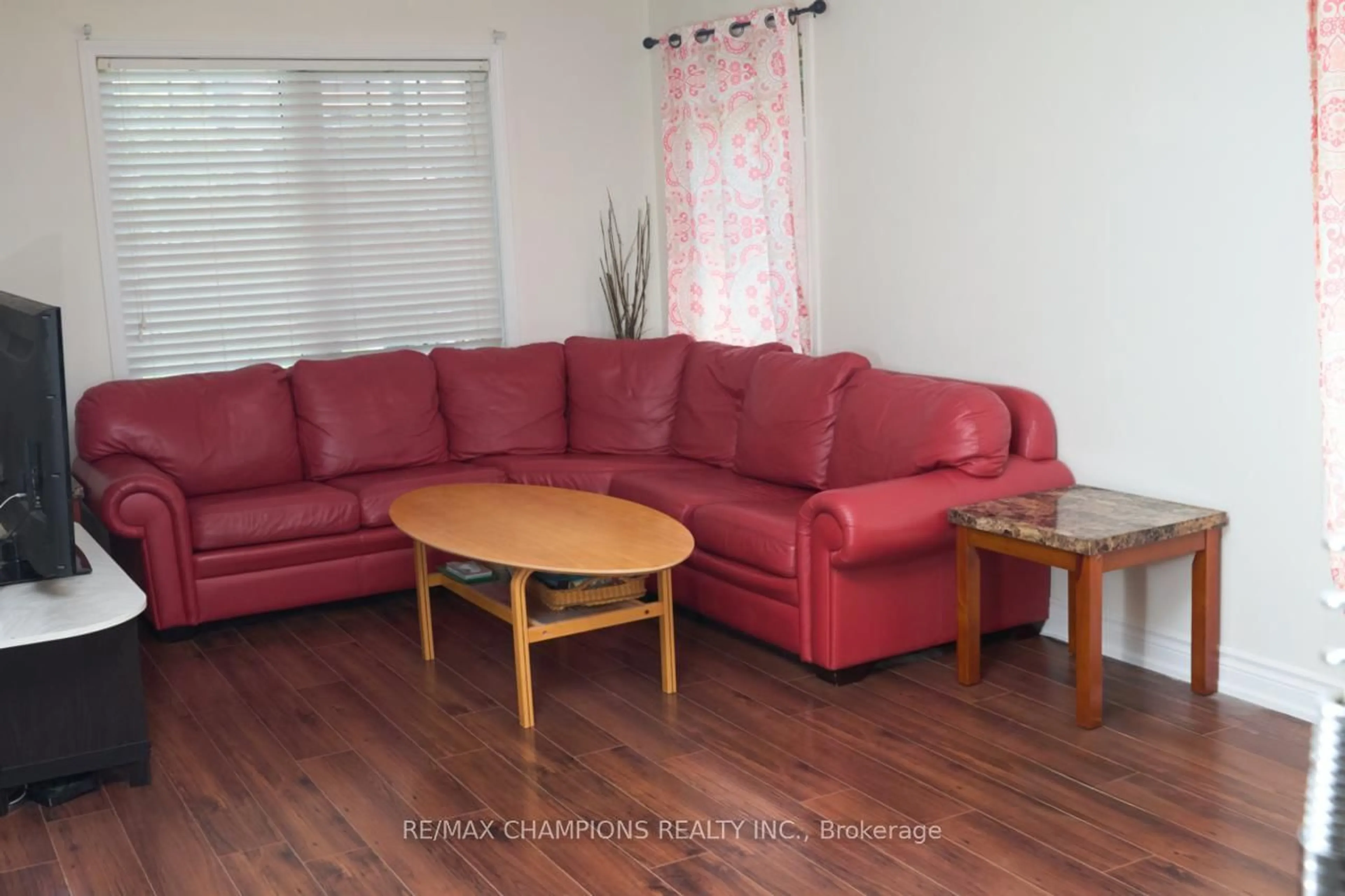 Living room with furniture, wood/laminate floor for 14 Yvonne Dr, Brampton Ontario L7A 3N5
